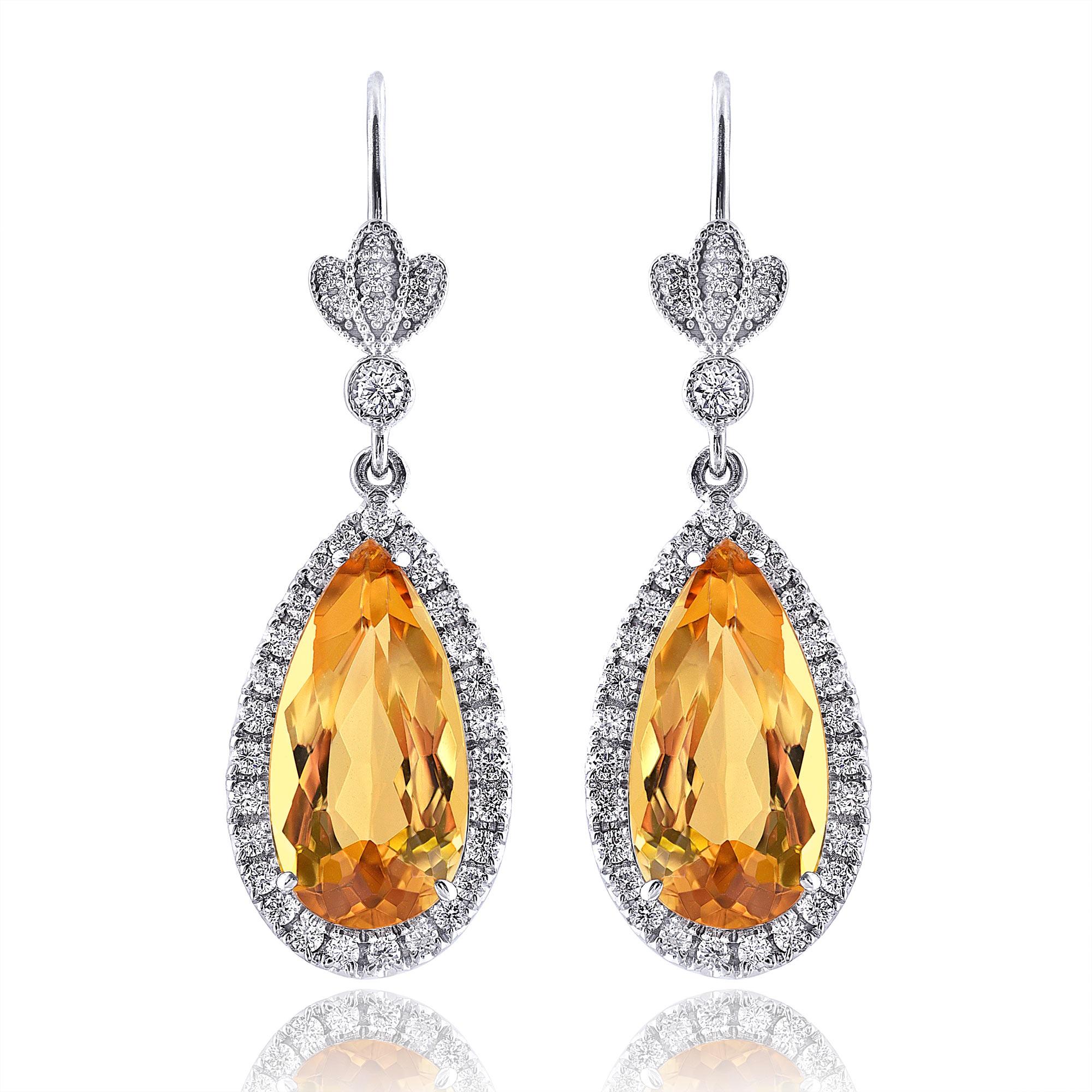 Bring the beauty of the sun with you by wearing these custom made 18K white gold dangle earrings, elegantly crafted in a rich shine. Elongated pear-shaped natural high-quality precious yellow topazes exhibit a warm orange-yellow hue, undeniably