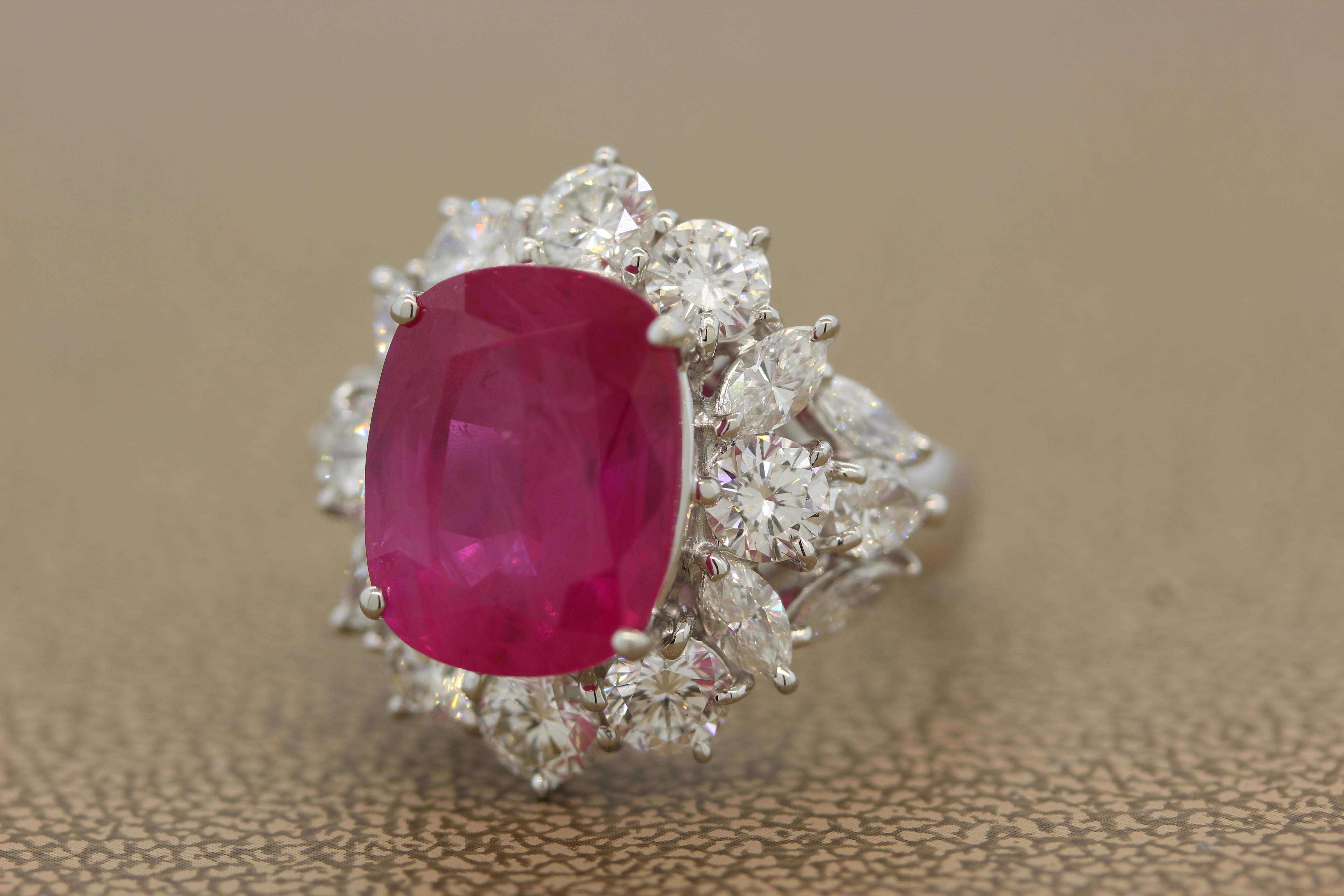 An exquisite ring featuring an AGL certified 10.27 carat pink sapphire originating from the most historic and rare source, Burma or present day Myanmar. The lavish cushion cut deep pink sapphire is haloed by 3.71 carats of colorless diamonds. The