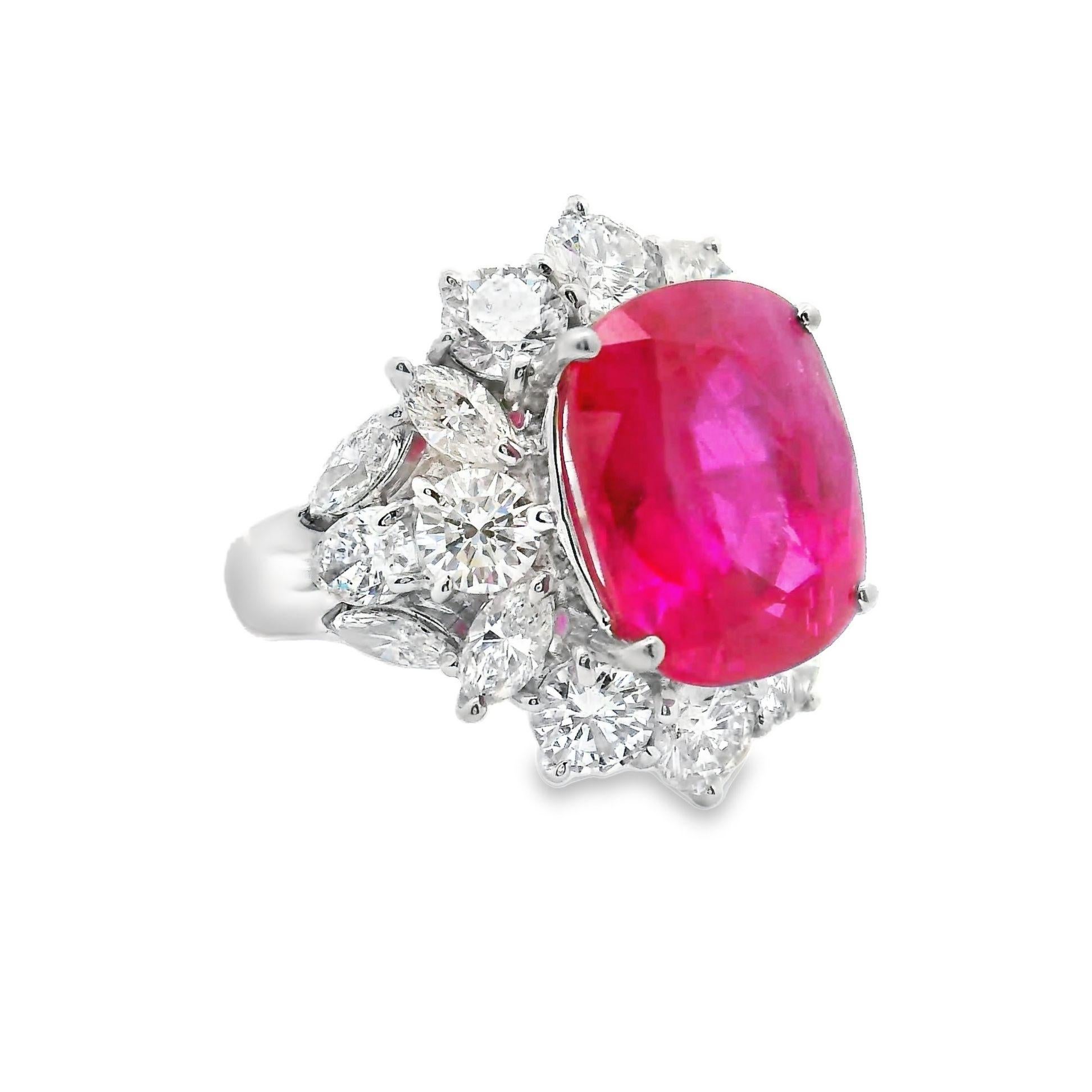 An exquisite ring featuring an GRS certified 10.27 carat ruby originating from the most historic and rare source, Burma or present day Myanmar. The lavish cushion cut deep ruby is haloed by 3.71 carats of colorless diamonds. The sparkling round,