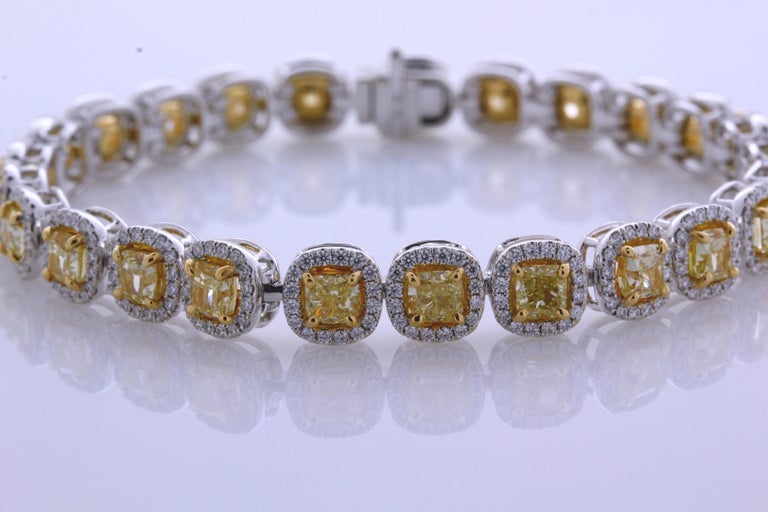 Video available upon request. 
10.28 Carat Cushion Cut, perfectly matched Natural Fancy Yellow, VS2+ Clarity Diamond Tennis Bracelet. Total Carat Weight on the Bracelet is 12.48.
This contemporary mounting is formed from 18 Karat White and 18K