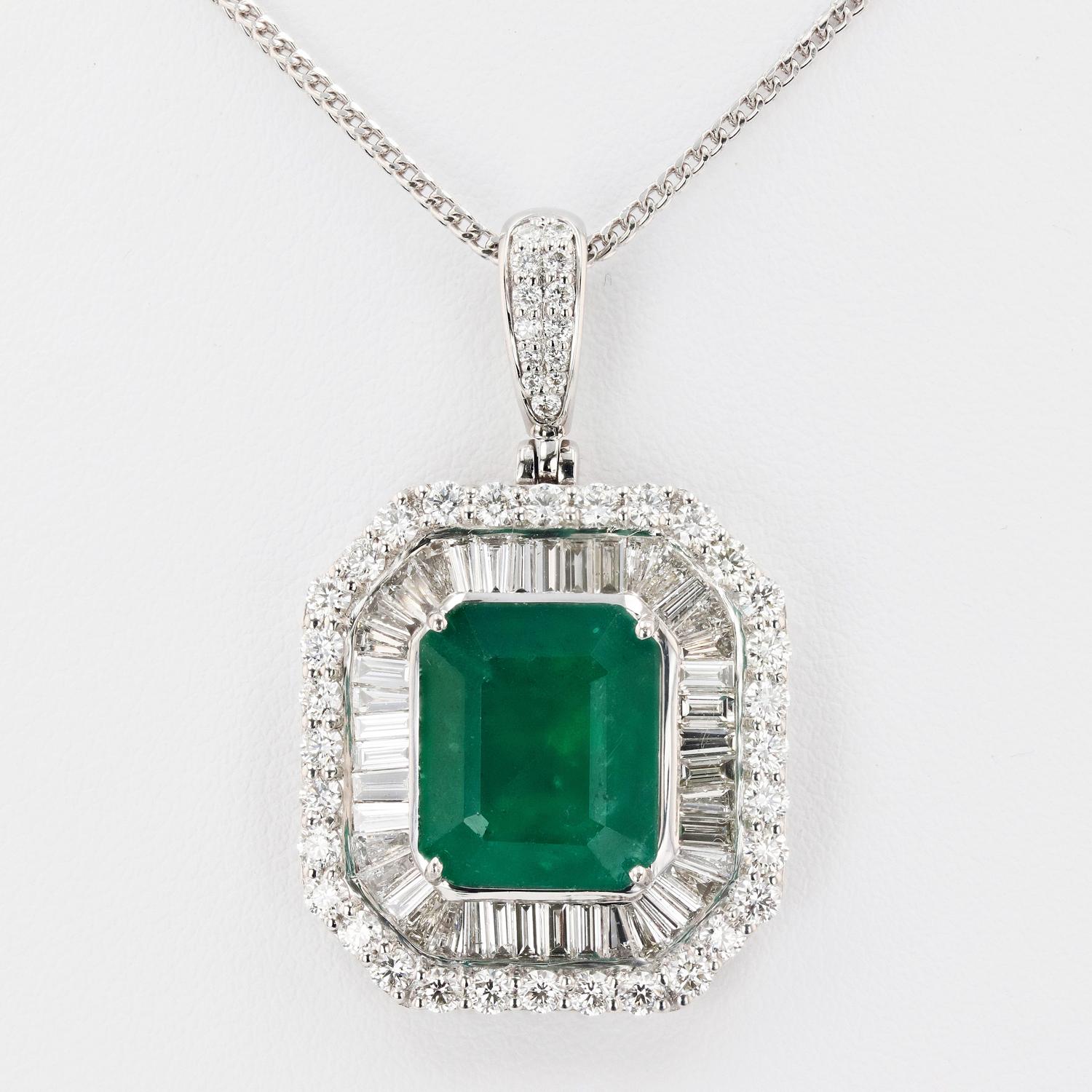 One polished, stamped, and tested platinum pendant mounted with: 1 genuine GIA certified emerald center stone weighing 10.28 carats, and 88 genuine faceted diamonds weighing approximately 3.51 carats. The pendant hangs from a platinum link chain
