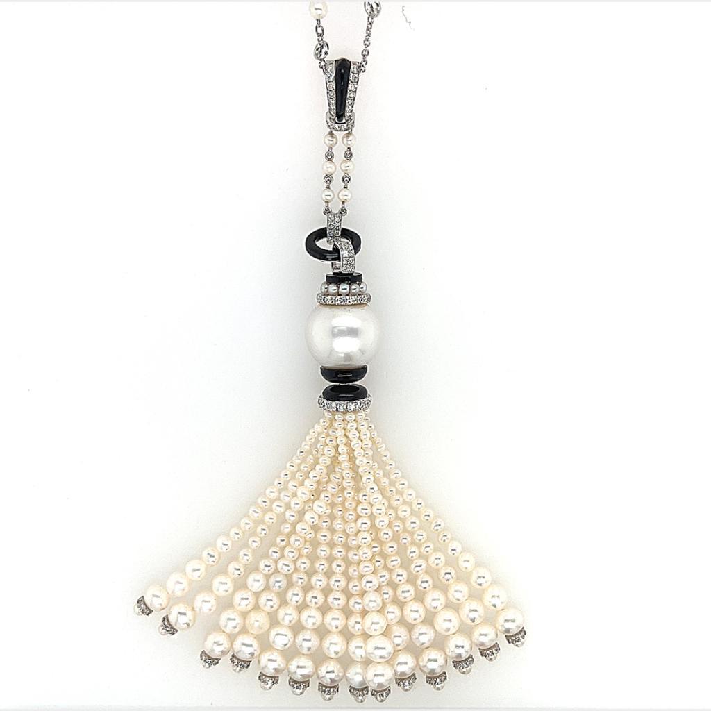 This is a gorgeous looking Cultured and Freshwater Pearl with Diamond and Onyx Tassel Necklace weighing 102.98 carats in total.  This stunning piece features glimmering beads with various cut and sizes of Freshwater Pearls and Diamonds set on 18