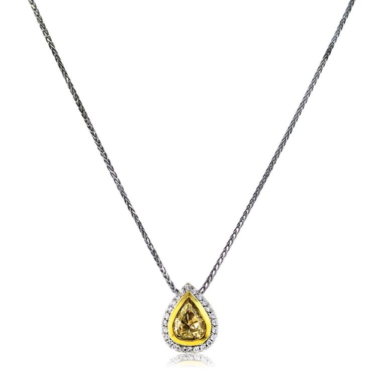 Style: 1.02ct Fancy Yellow Pear Shaped Diamond Pendant on Chain
Main Diamonds: Pear Shape (1.02ct)
Diamond Carat Weight: 1.42 Carat Total Weight
Diamond Color: Fancy Yellow
Diamond Clarity: SI2
Mounting Details: Stones are Set in an 18K White and