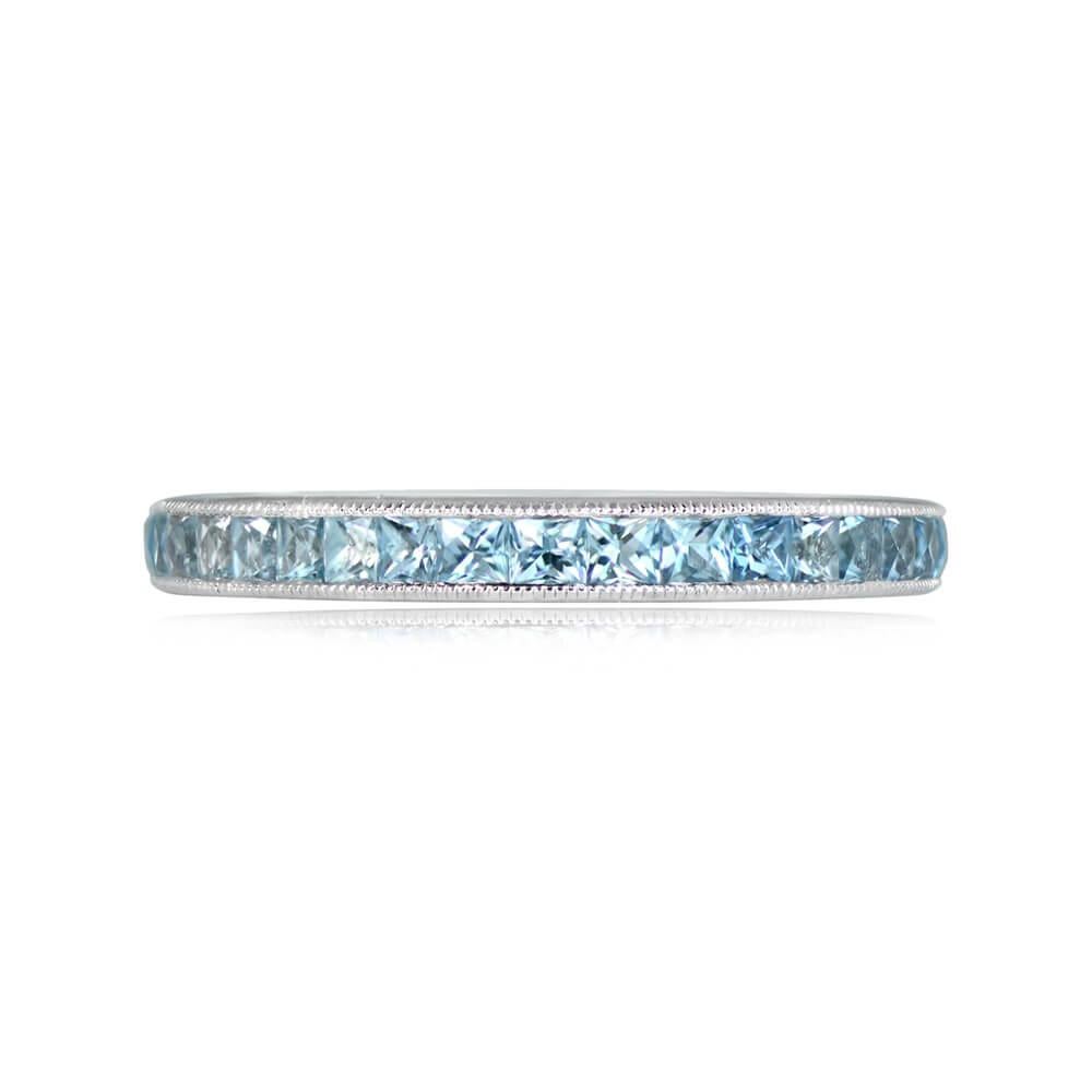 Elegantly crafted, this platinum eternity band showcases French-cut aquamarines, channel-set to perfection. The total weight of the aquamarines is approximately 1.02 carats, creating a captivating display of subtle blue hues. The band is adorned
