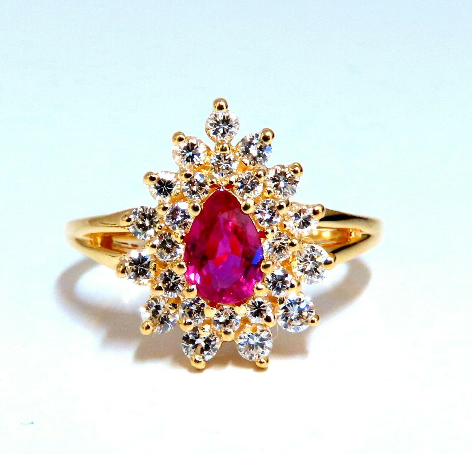  .60ct. Natural Ruby Cocktail Halo ring 
Pear cut 
Fully faceted Clean clarity
 5.3 x 3.4mm
Vivid Red / Vs Clear Clarity
.42ct. Diamonds:  Rounds, full cuts 
 G-color, Vs-2 clarity. 
 14kt. yellow gold. 
 3.2 grams. 
Deck of ring: 14mm x 11mm
