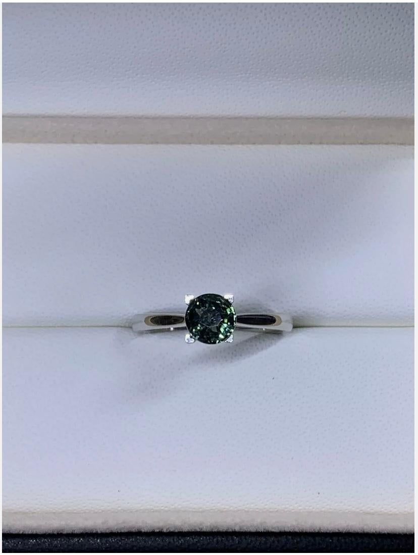 1.02ct Teal Sapphire Solitaire Engagement Ring 18ct White Gold
This stunning engagement ring features a 1.02ct round teal sapphire set in 18ct white gold. The solitaire setting style showcases the natural beauty of the gemstone. The ring is size M