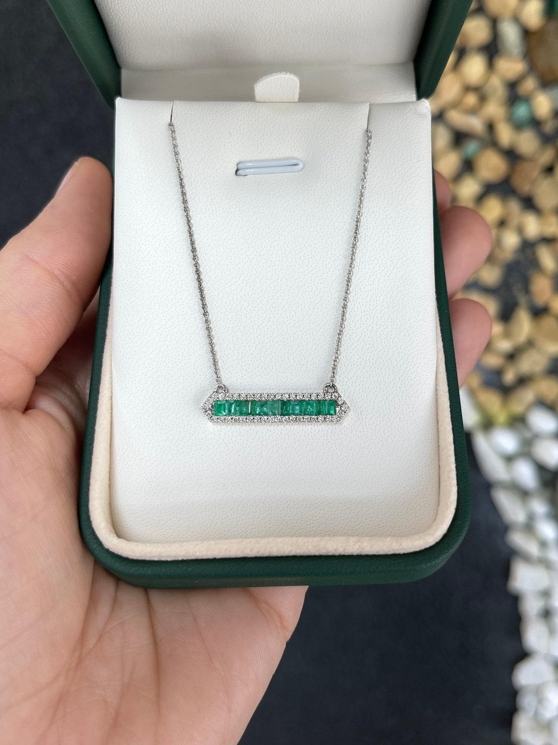 Introducing our exquisite Emerald and Diamond Bar Pendant Necklace, a stunning piece that encapsulates the perfect fusion of elegance and contemporary style. This pendant showcases a captivating green bar, meticulously created by vertically set