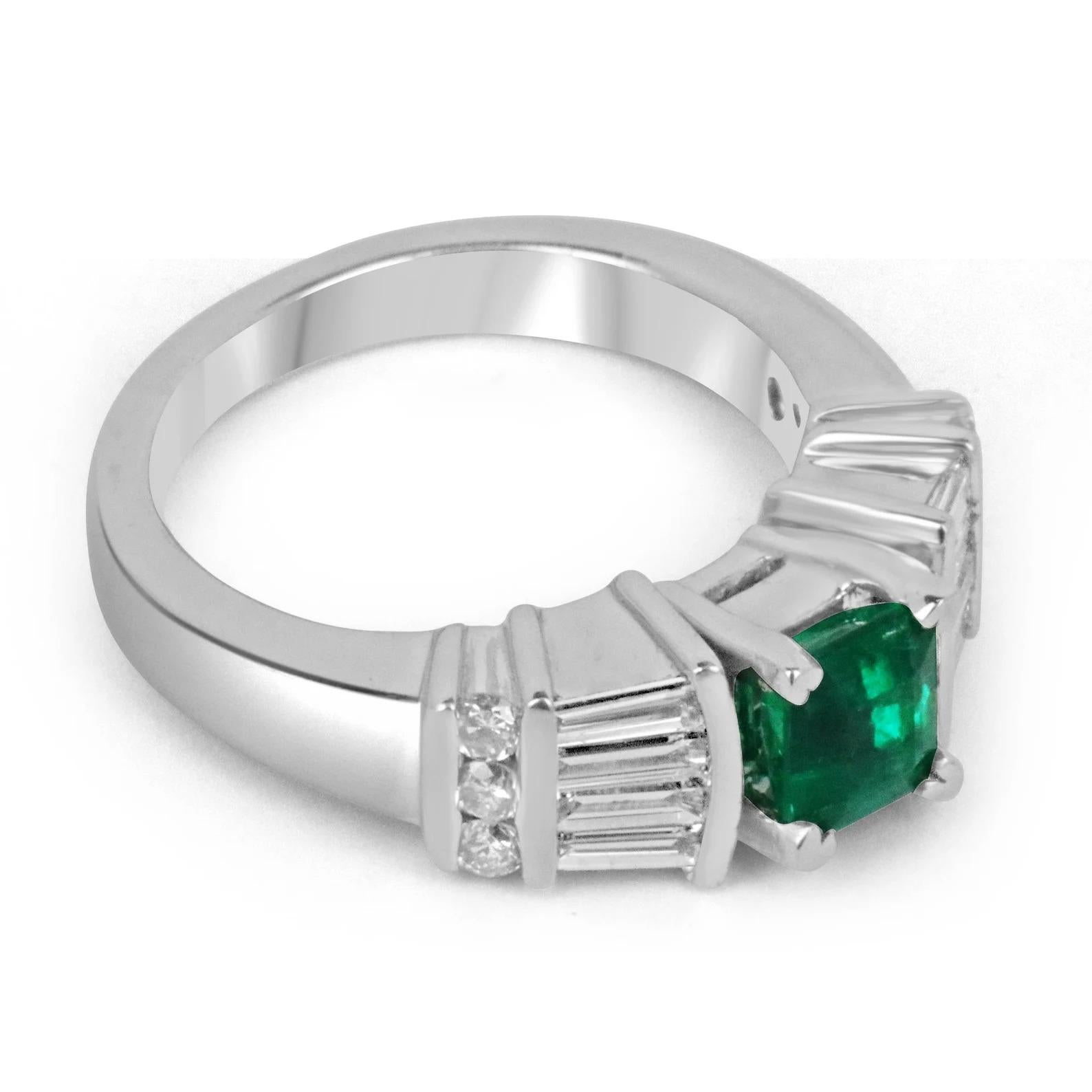An exquisite fine quality AAA Colombian emerald and diamond ring. The center gemstone showcases almost a full carat of pure Colombian, AAA+ emerald goodness! Displaying the most enthralling, vivid, dark green color and excellent luster. Set in a