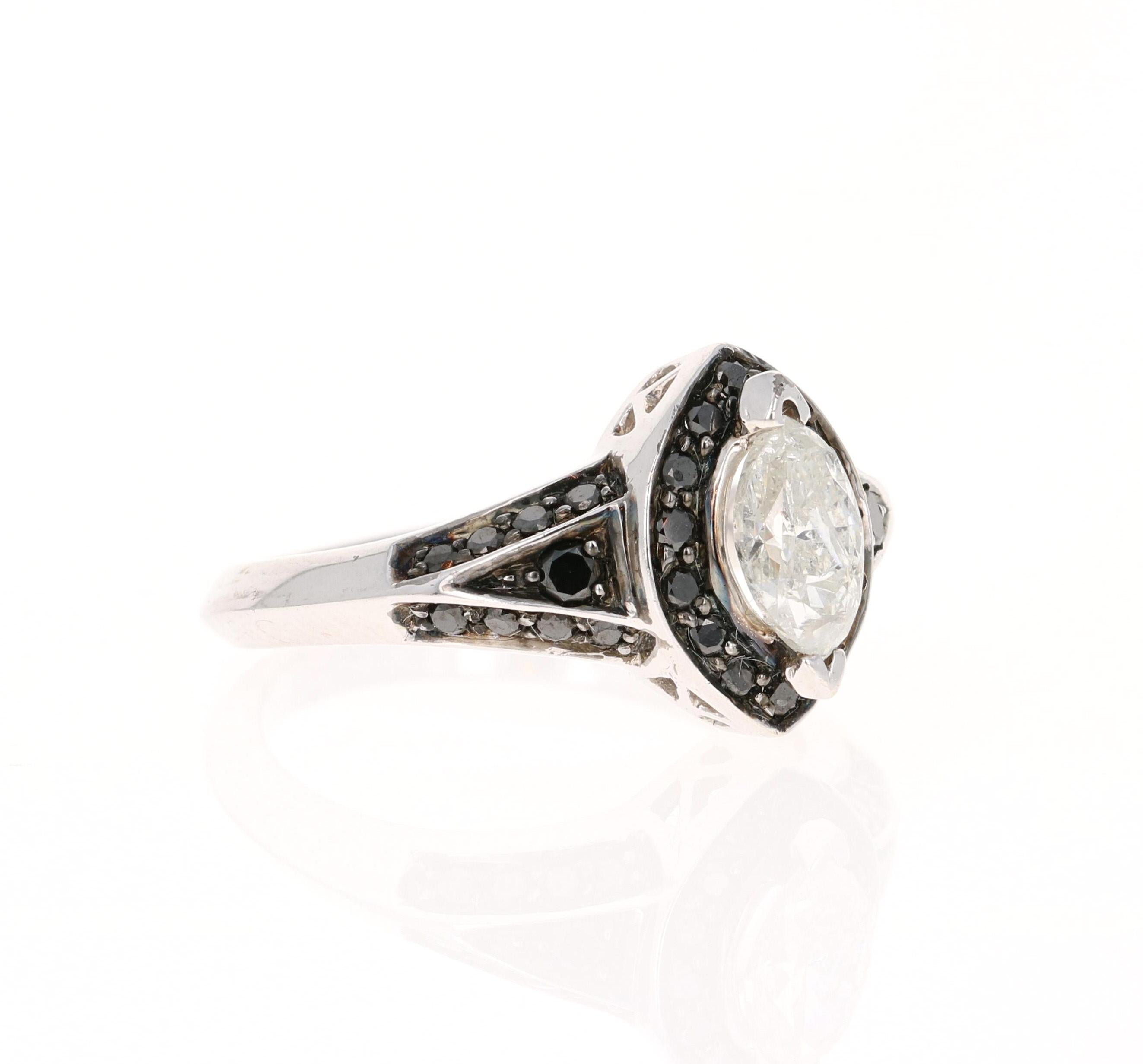 This ring has a Marquise Cut Diamond that weighs 0.63 carats. There are also 36 Round Cut Black Diamonds that weigh 0.40 carats. The total carat weight of the ring is 1.03 carats. 

The ring is set in 14 Karat White Gold and has an approximate gold