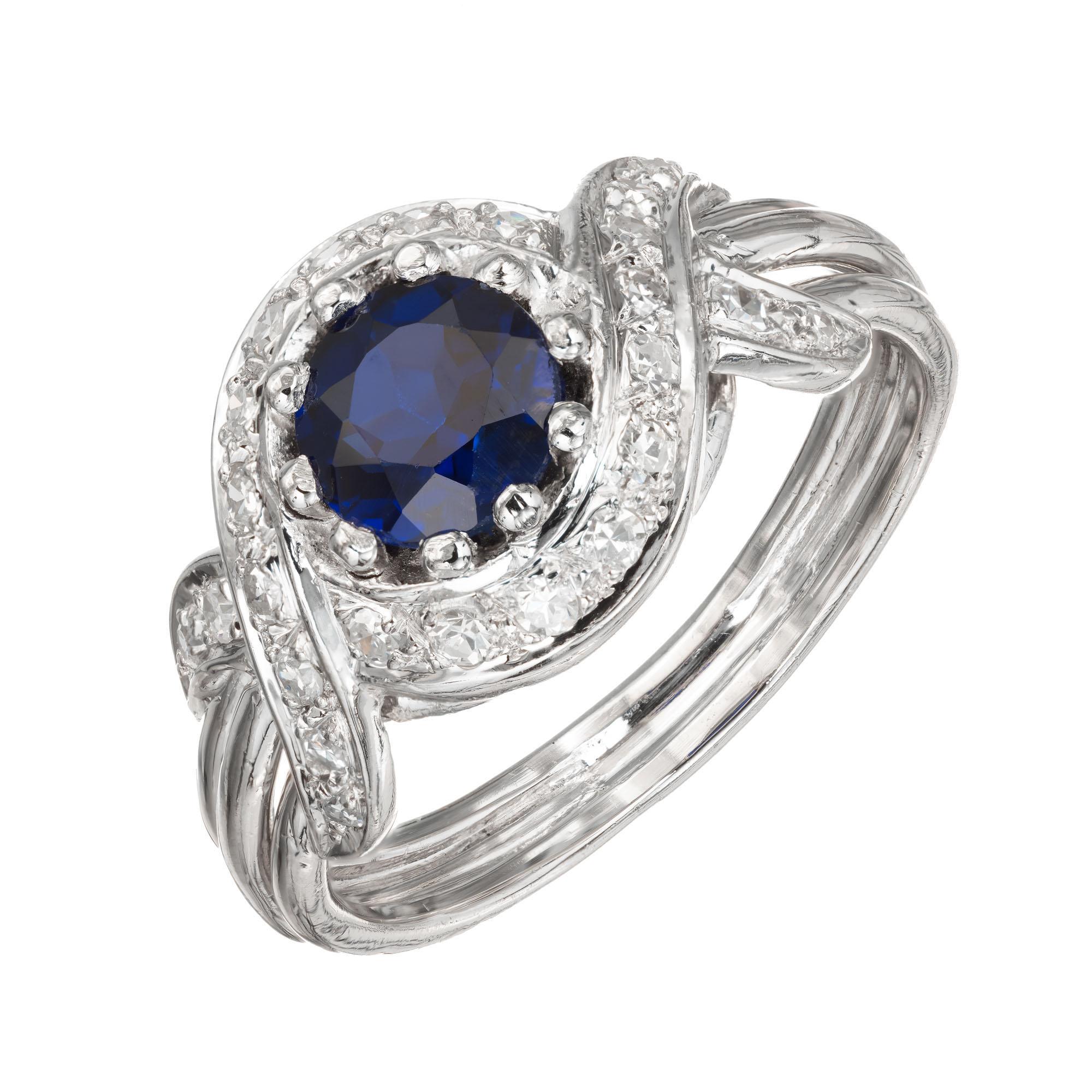 Sapphire and diamond engagement ring. Round Ceylon center stone in a handmade wire ring with a halo of round diamonds in a Platinum swirl design setting.  circa 1970.

1 round Sapphire approx. total weight 1.03cts, 5.8mm
24 round diamonds approx.