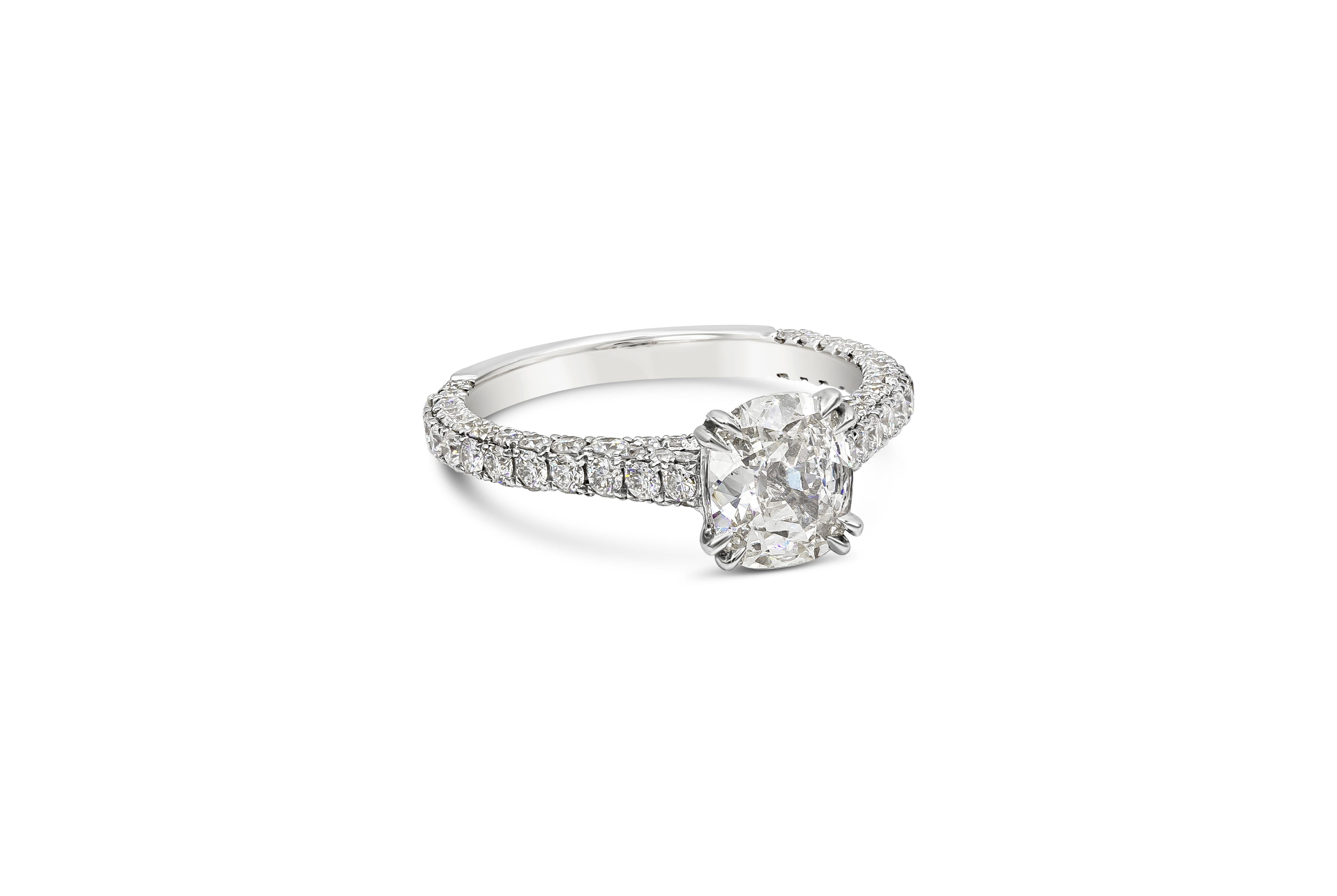 A classic engagement ring style showcasing a 1.03 carats cushion cut diamond, certified by EGL as G color, VS1 in clarity and set in a timeless eight prong basket setting. Accented with brilliant round diamonds on the shank of the ring weighing 1.05