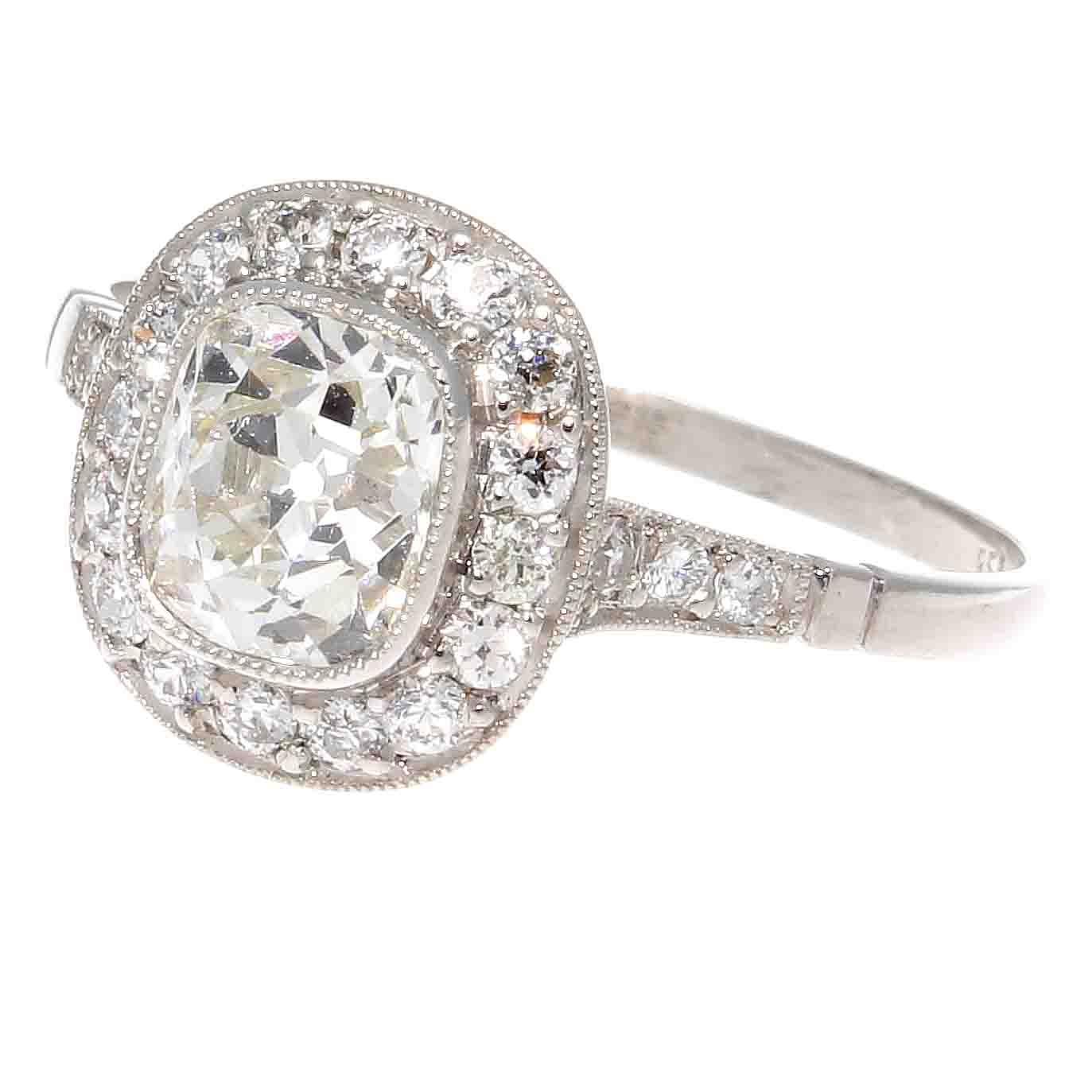 Tradition that lasts as long as a loving marriage. Featuring a 1.03 carat old mine cut diamond that is J color, VS2 clarity. The hand crafted platinum ring features a halo of near colorless diamonds.

Ring size 5 and can easily be resized to fit, if