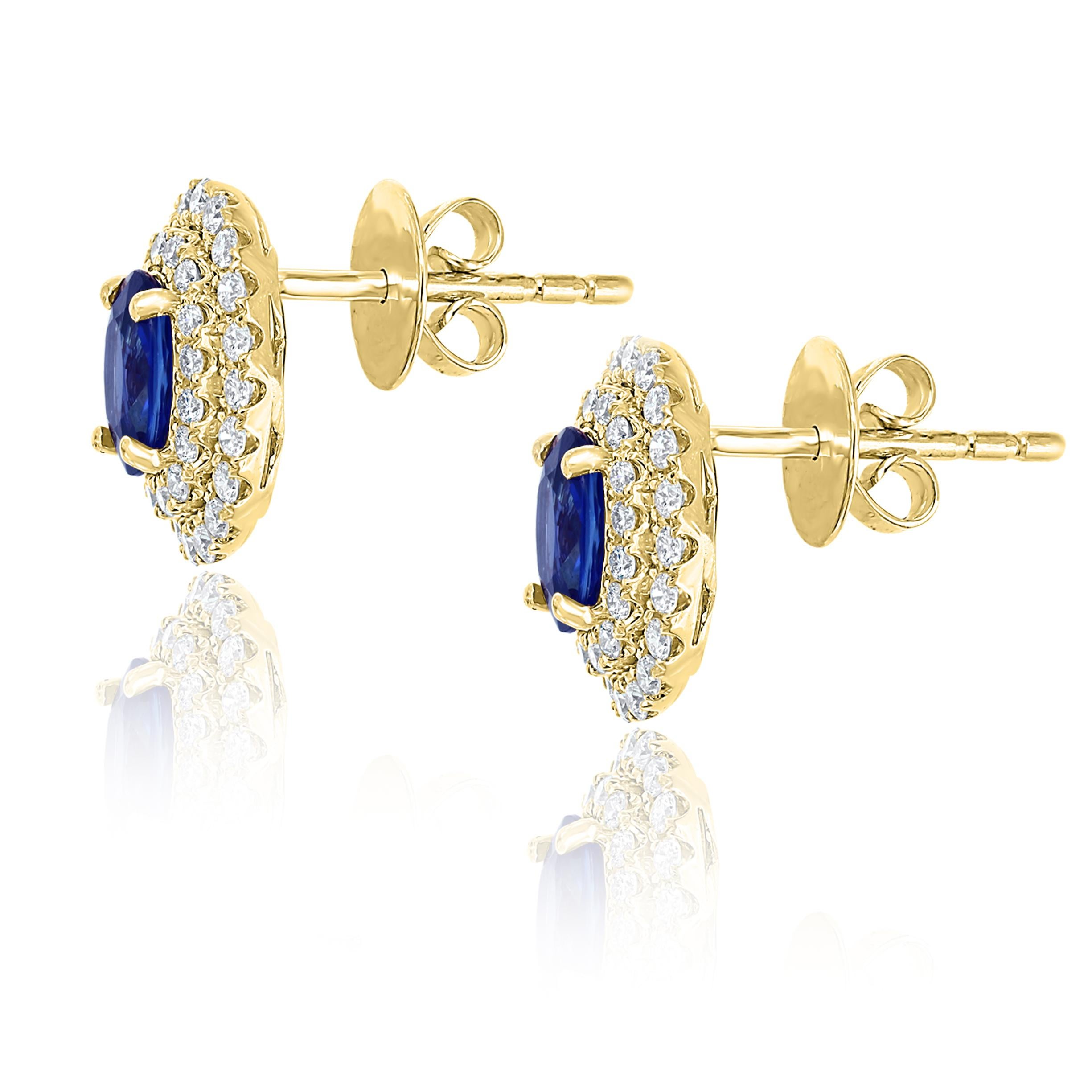 A simple pair of stud earrings showcasing 1.03 carats of oval cut blue sapphires, surrounded by a double row of 72 round brilliant diamonds weighing 0.48 carat. Made in 18 karats yellow gold.  