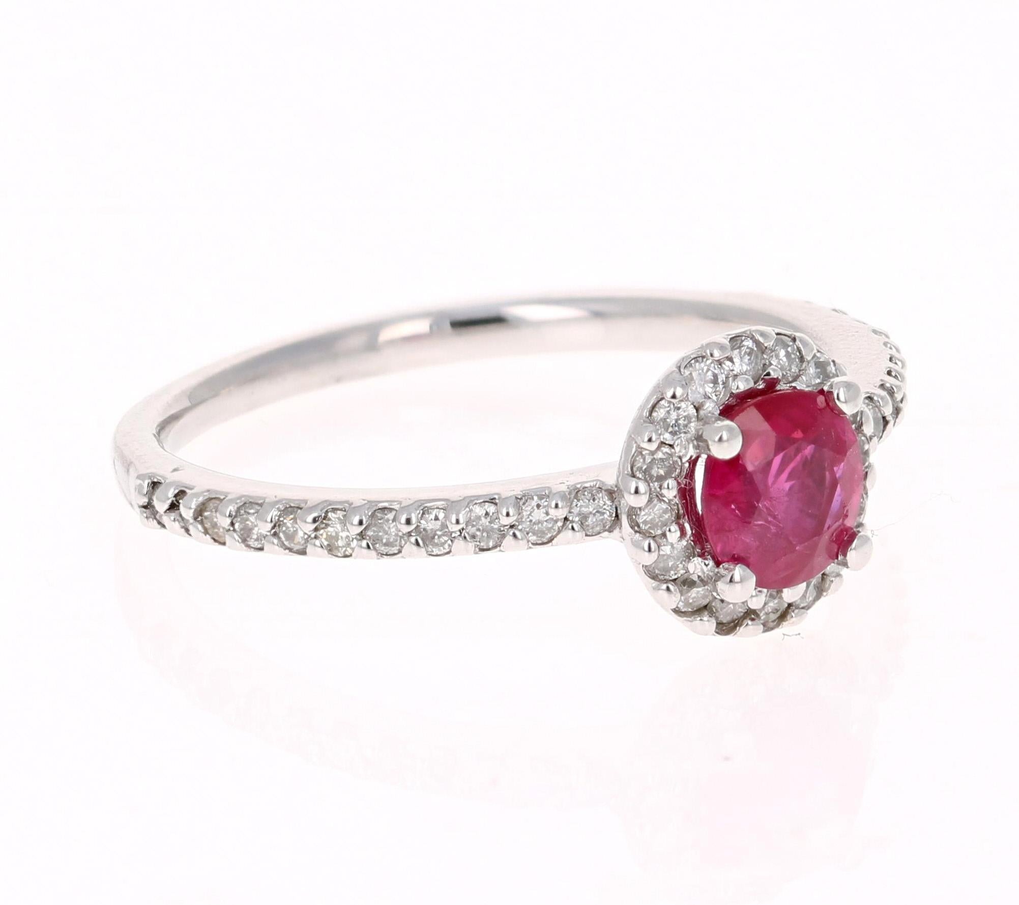Simply beautiful Ruby Diamond Ring with a Round Cut 0.66 Carat Burmese Ruby which is surrounded by 38 Round Cut Diamonds that weigh 0.37 carats. The total carat weight of the ring is 1.03 carats. The Round Cut Ruby measures at 5.5 mm and the face of