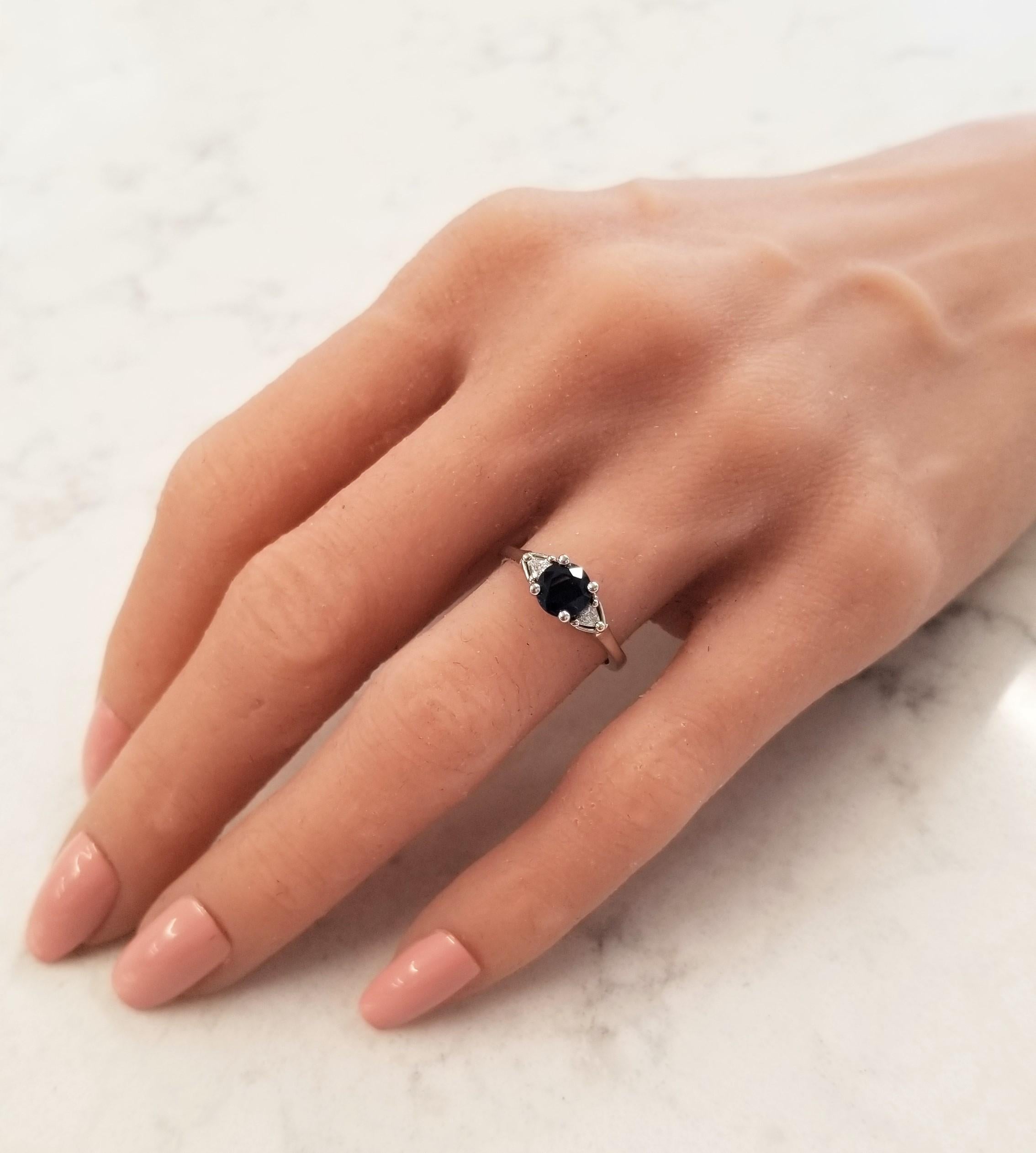 Simple, yet so elegant! This exceptional 3 stone ring will quickly become one of your favorite pieces of jewelry to wear or to gift. The star of this show is the vibrant 1.03 carat round sapphire, from Thailand, that sits in the center of the ring.