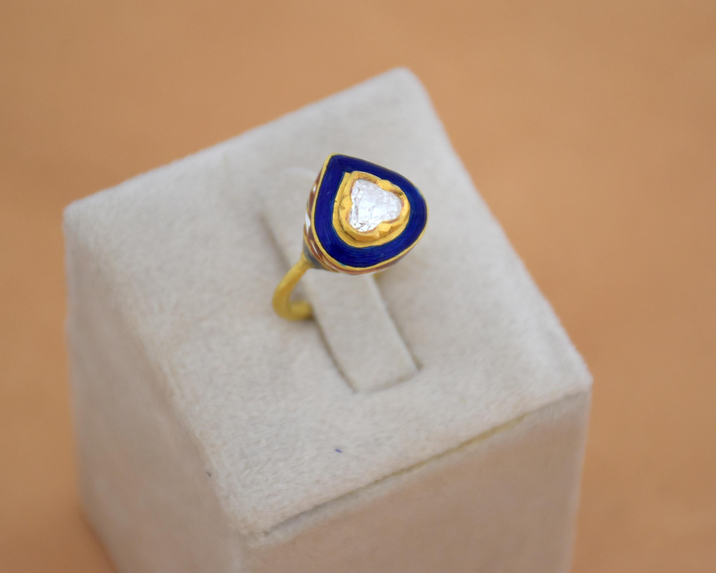 With a centre heart shape 1.03 ct natural rose cut diamond with loupe clean purity, this ring is a testament to true enamelling artistry born in early 18th century. The ring done in 22K gold has blue enamelling on the top and red and white colour