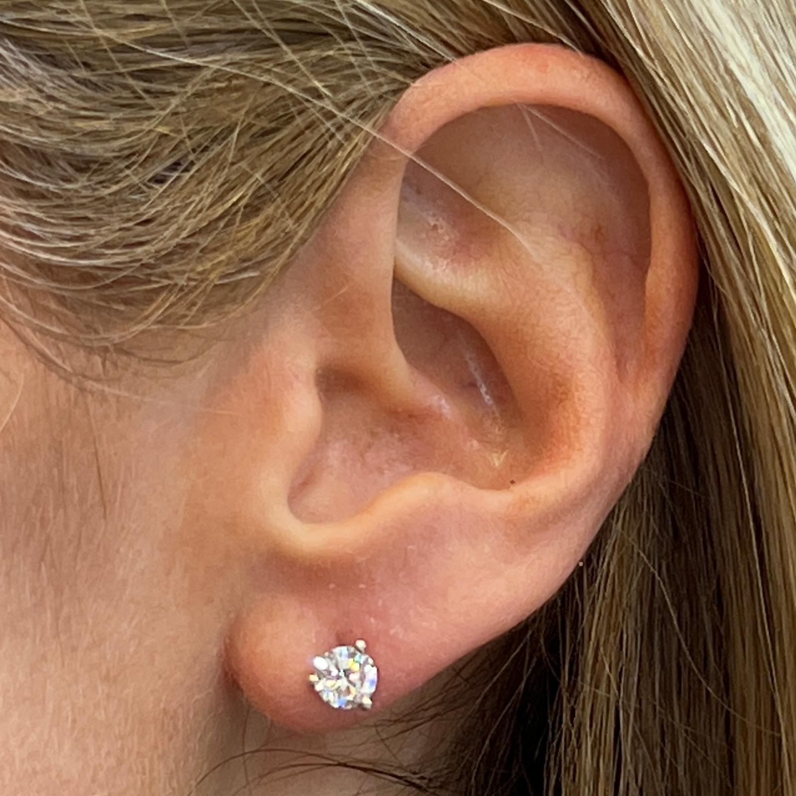 GIA Certified diamond stud earrings set in 14 karat white gold martini style mountings. The two diamonds weigh 1.03 carat total weight and are graded I color and VS1-2 clarity. See GIA reports for more information. 