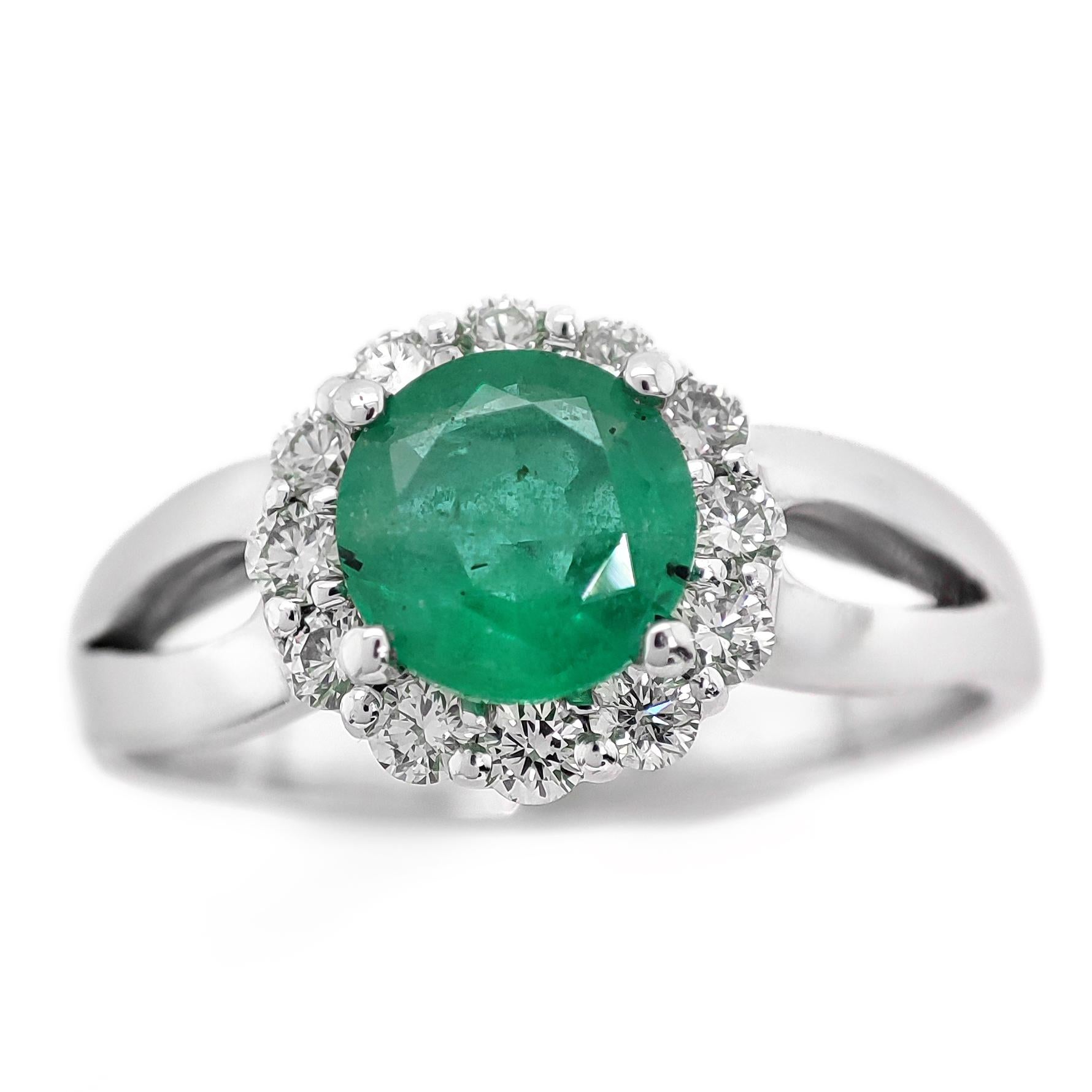 FOR US BUYER NO VAT

This exquisite ring features a 0.73 carat round green emerald at its center, displaying the captivating and vibrant green color that emeralds are cherished for.

Complementing the emerald's beauty are 12 diamonds, totaling 0.30