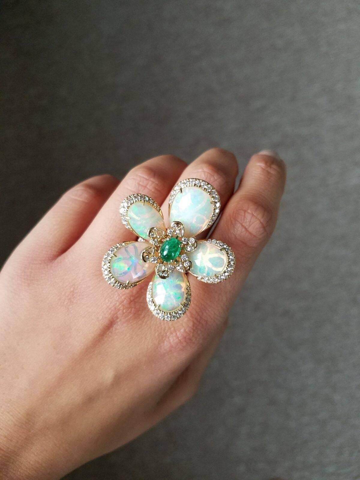 A statement, intricatally hand-made cocktail ring. Using 10.30 carat fancy rose-cut, Ethopian Opal floral ring with Zambian Emerald and Diamonds set in 18K rose gold. 

Stone Details: 
Stone: Opal
Carat Weight: 10.30 Carats

Diamond Details: 
Total