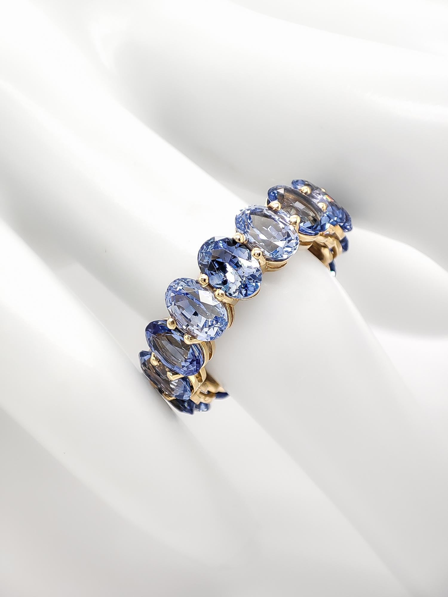 FOR US BUYERS NO VAT

Radiate timeless beauty and grace with this extraordinary 14K yellow gold eternity ring showcasing 16 stunning sapphires totaling an impressive 10.30 carats. The sapphires, in shades of light to medium blue, create a harmonious