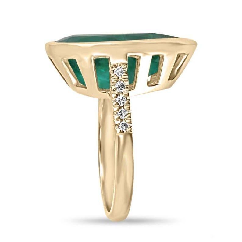 This exquisite ring showcases a stunning 10.10-carat pear-cut natural emerald, radiating a deep dark green hue with semi-transparent clarity. The emerald is securely bezel-set for protection, while brilliant round-cut diamonds flank the shank,
