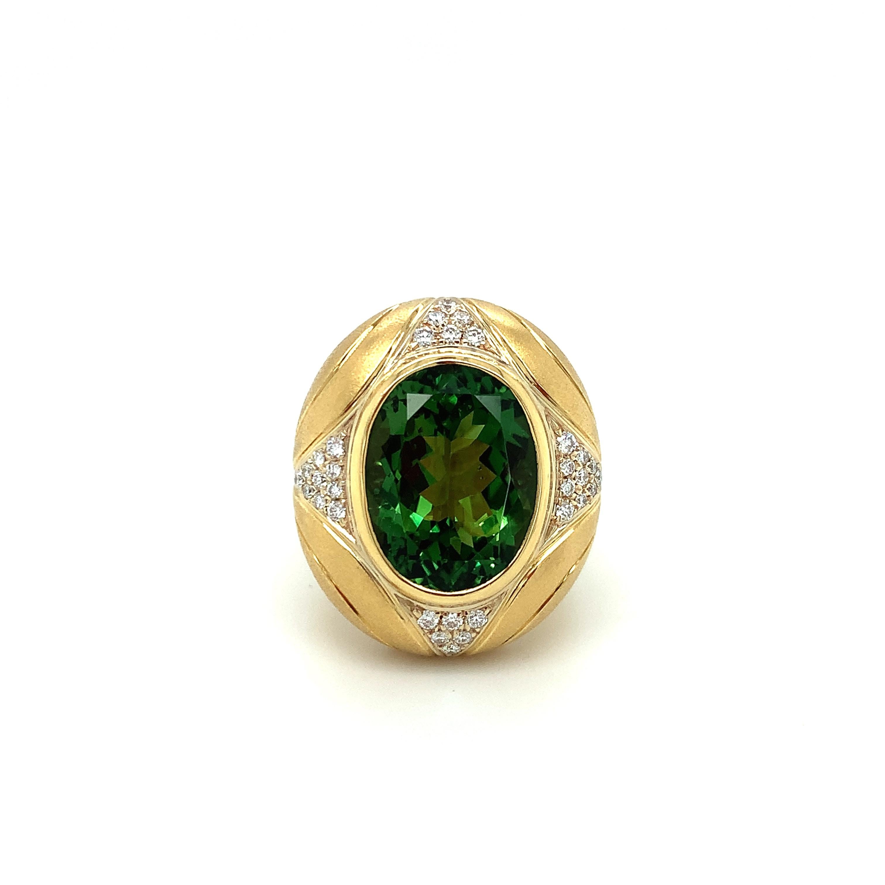 A vibrant, rich green 10.31 carat tourmaline oval is featured in this gorgeous, custom-designed 18k yellow gold  ring. The tourmaline is a gem in every respect, possessing exceptional color, excellent clarity and a beautiful cut. This regal-looking