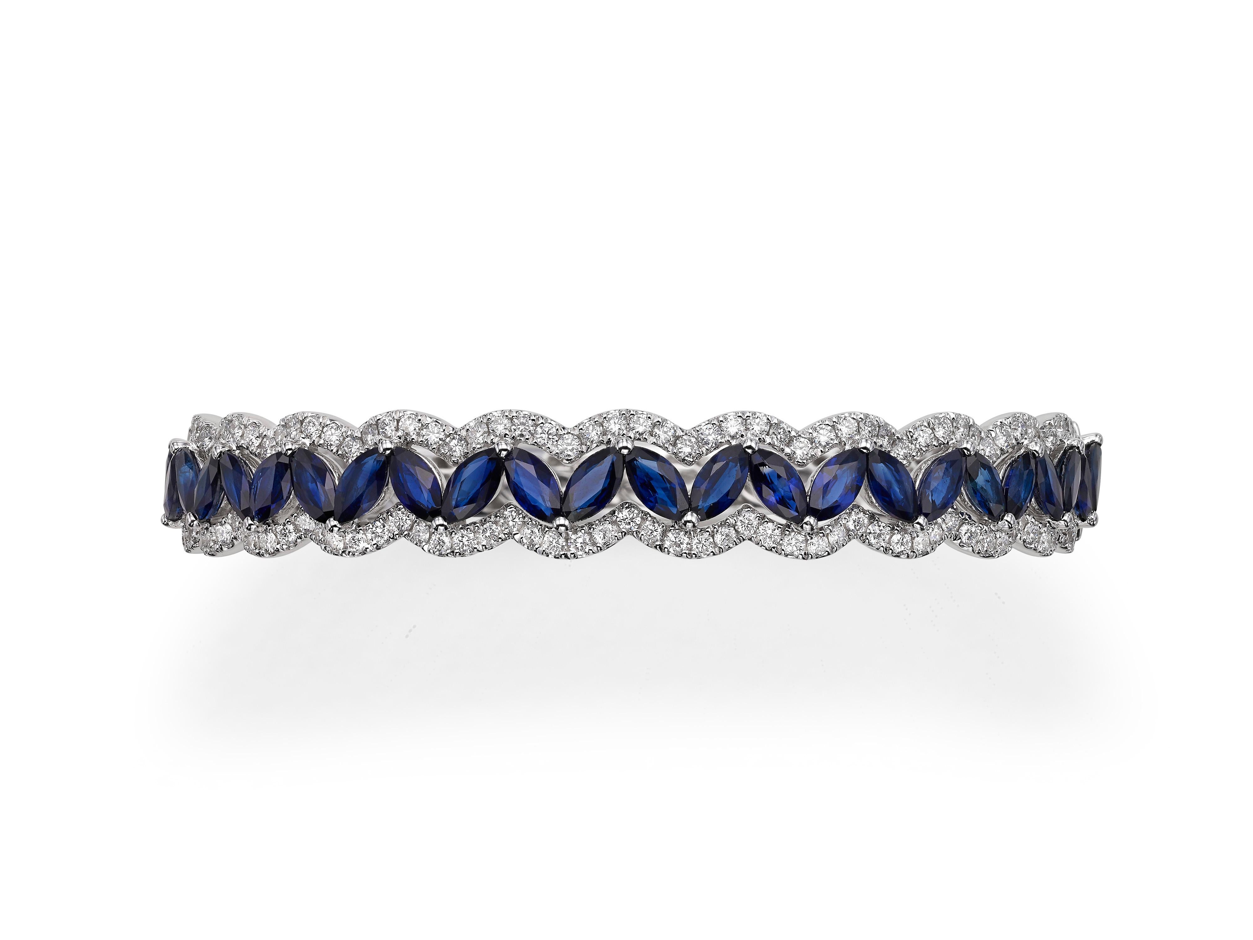 Handmade from 18K white gold, encrusted with 8.71 carats of marquise-shape blue sapphires and 1.62 carats of round brilliant cut diamonds.  Perfectly complements the Butani Marquise Sapphire Round Diamond 18 Karat White Gold Eternity Band
