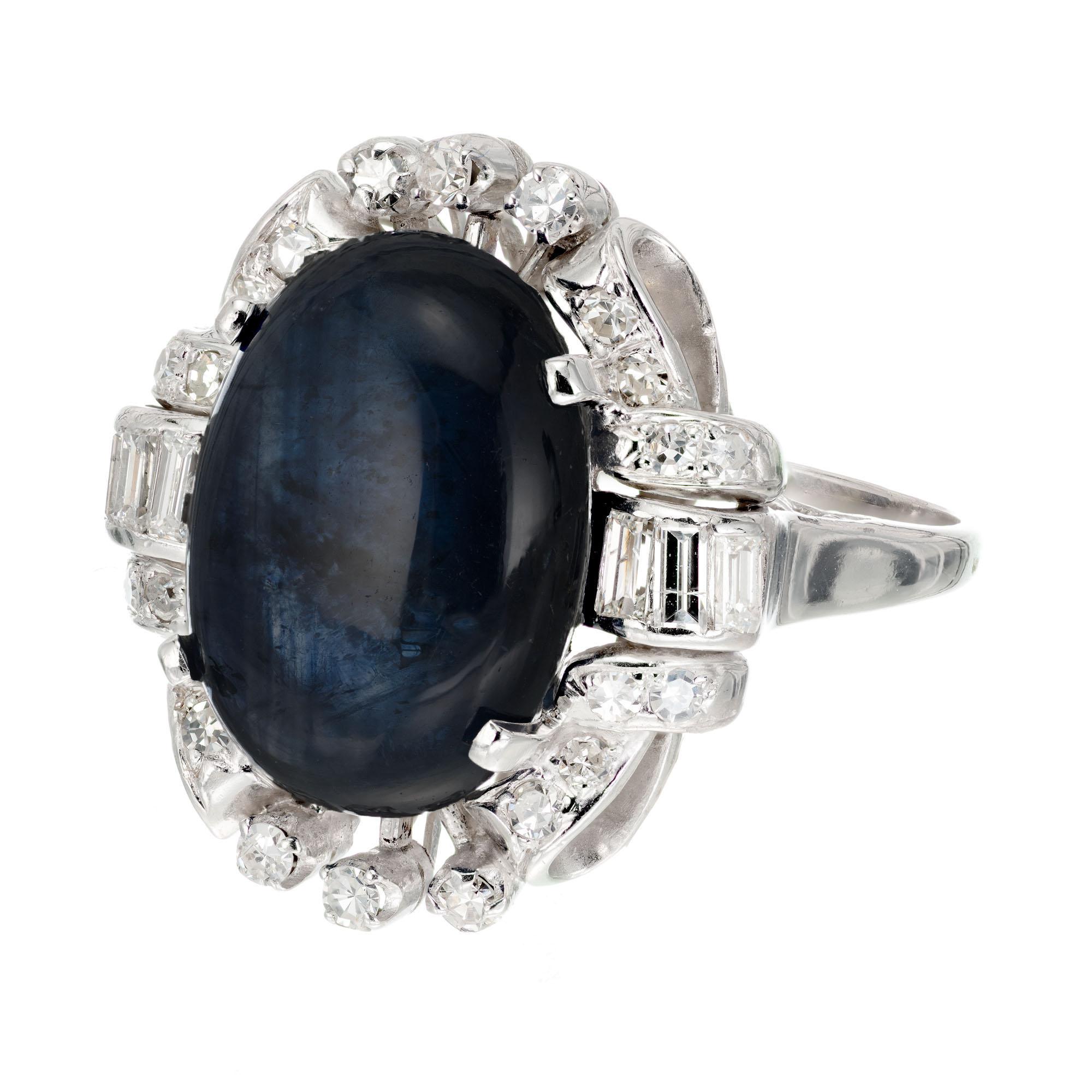 10.33ct oval cabochon sapphire with a halo of 28 mixed shaped diamonds in a handmade 14k white gold setting. Circa 1930.

1 oval cabochon cut sapphire approx. total weight 10.33cts   15.16mm top to bottom of stone and 11.15mm across. Or,  .60 inch