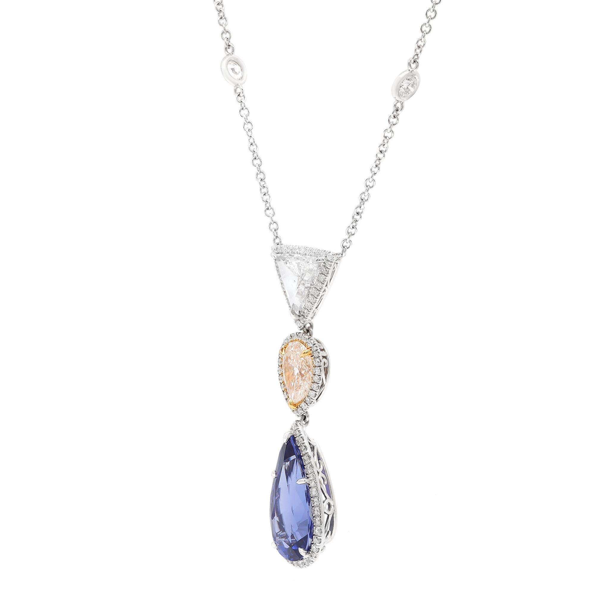 Made to win your heart at first sight! This lavish and enchanting masterpiece is adorned with captivating Pear shaped Natural Tanzanite weighing 10.34 carats. Pear shaped faint yellow diamond weighing 1.81 carats with color K and clarity VS1. The