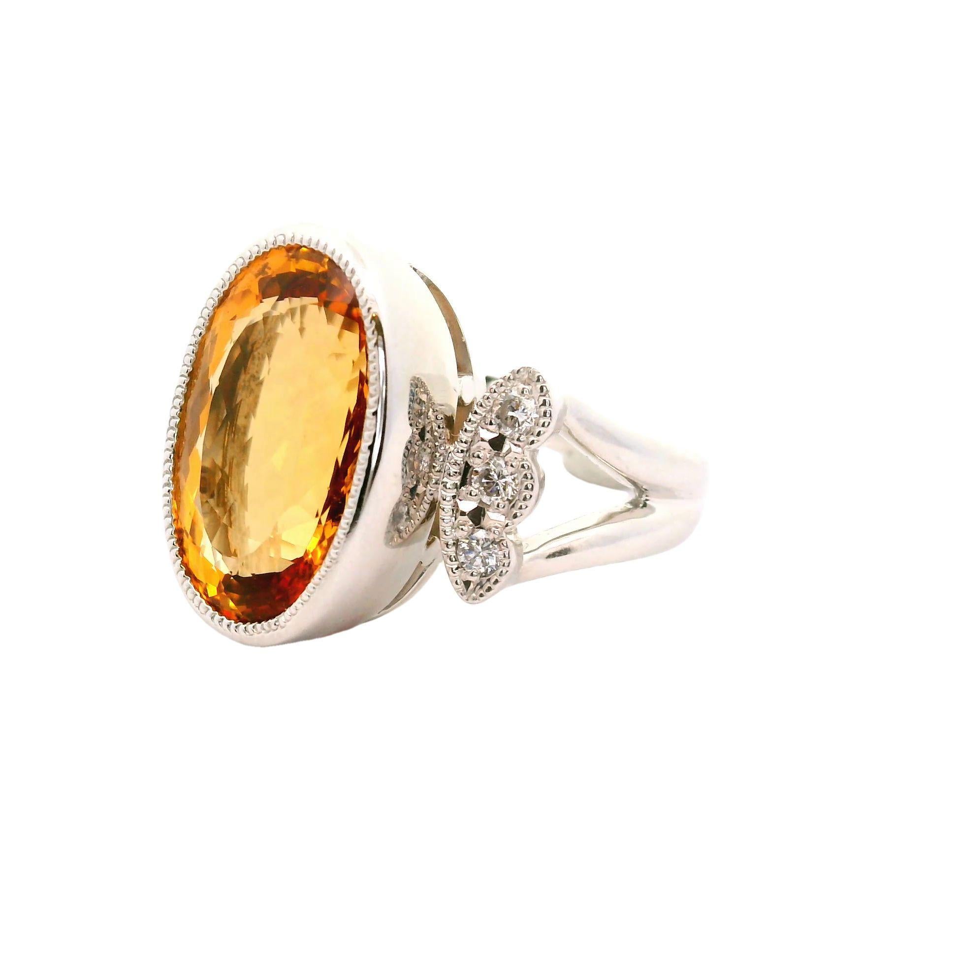 A sweet and juicy gem, a 10.36 carat imperial topaz takes center stage. It has a rich and vibrant golden yellowish-orange color that shines intensely. It is complemented by 6 round brilliant-cut diamonds set on the sides of the topaz and weighing