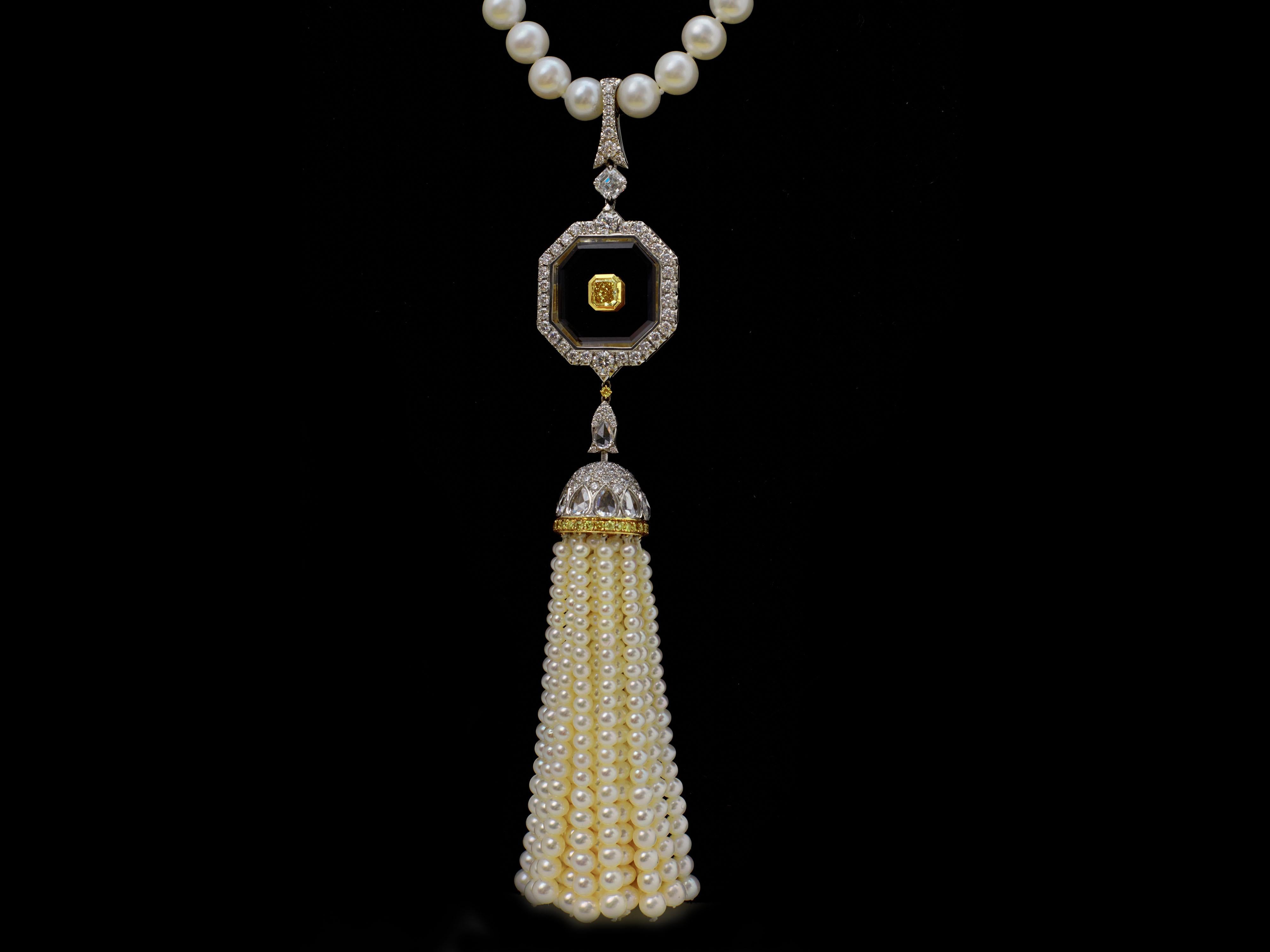 This luxurious Art Deco style, showcase a stunning 0.56 Carat Vivid Yellow diamond radiant-cut GIA certified as VS2 clarity in the center and a 0.66 emerald cut Diamond GIA certified as F color, VS2 clarity & Pearls Tassel Pendant Necklace, set in a