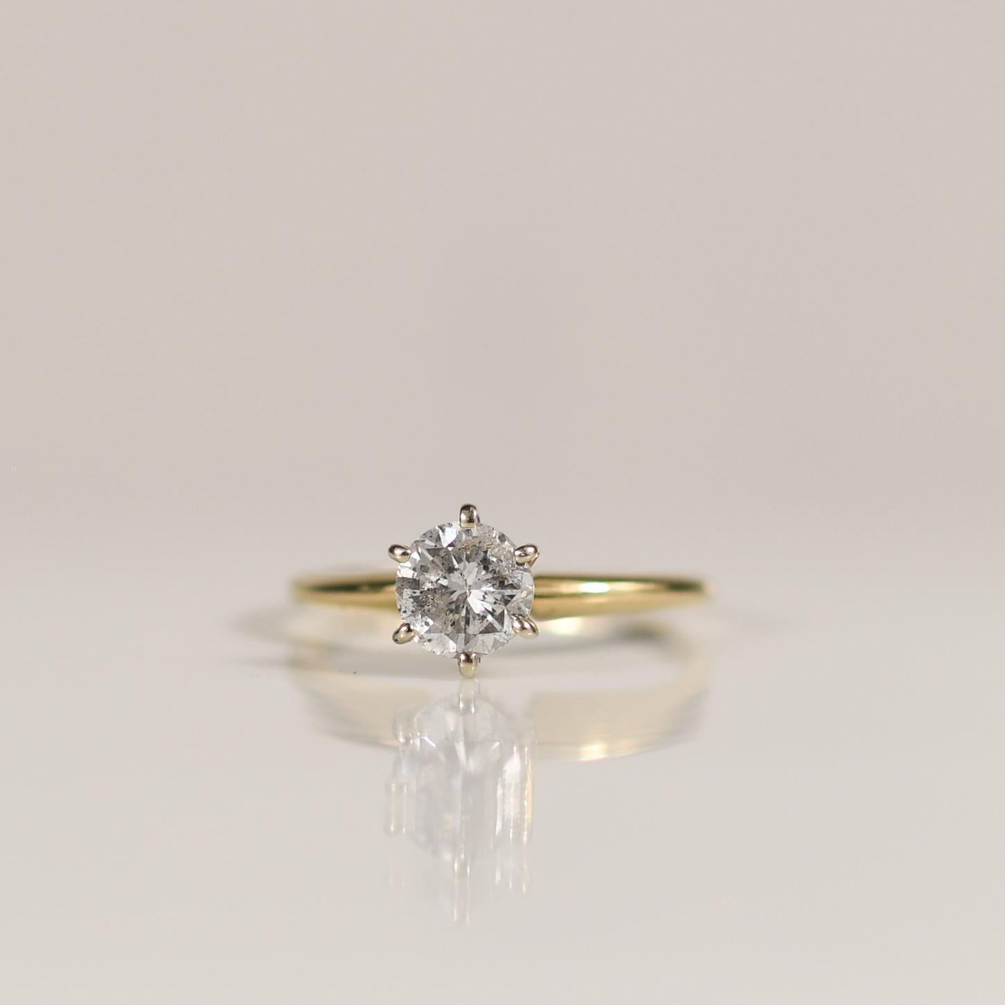 Dieser Solitärring aus 14 Karat Gelbgold mit einem runden Diamanten im Brillantschliff steht für schlichte Eleganz. Die Schlichtheit des Designs lässt die außergewöhnliche Brillanz des Diamanten in den Vordergrund treten und macht ihn zu einer