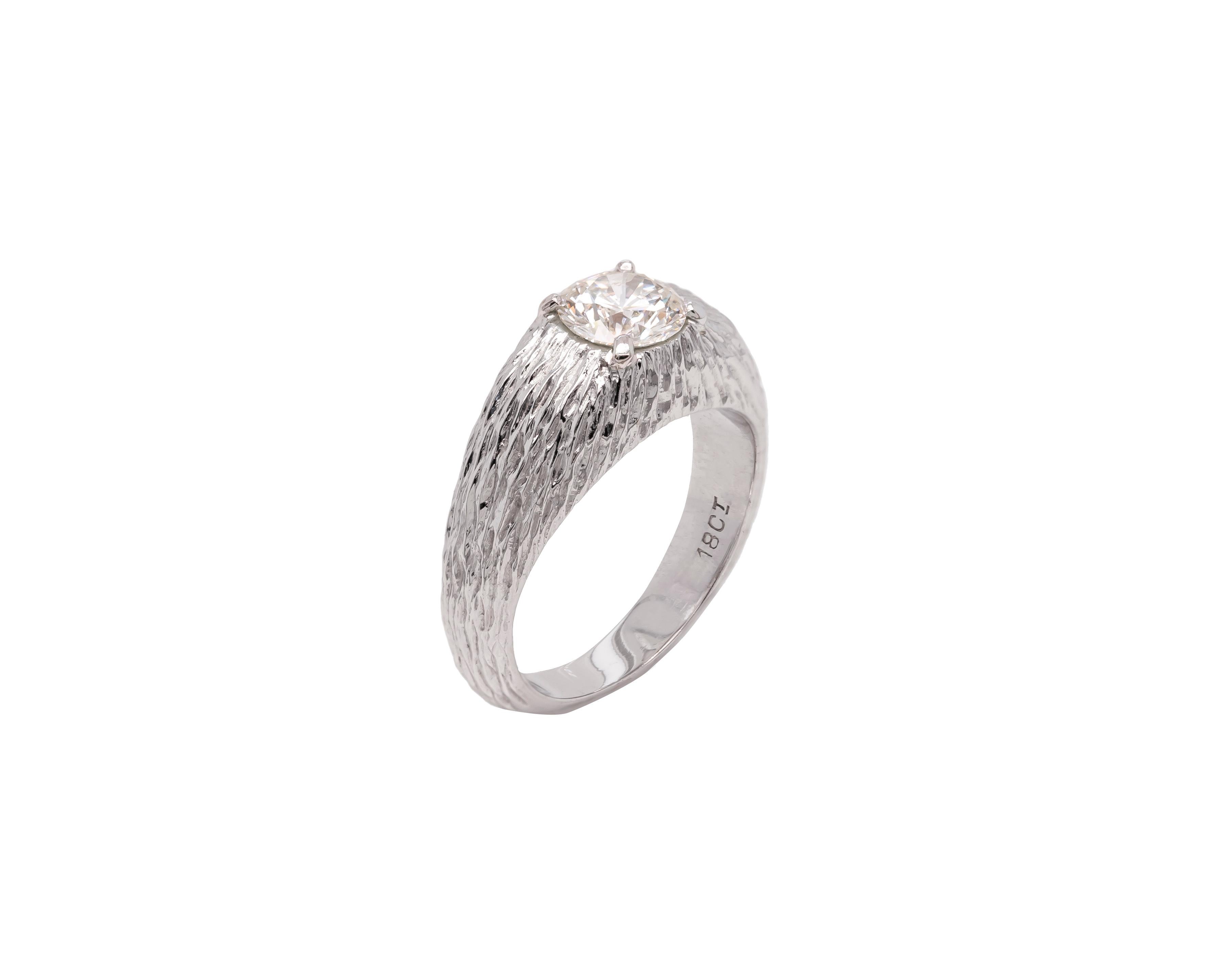 A gorgeous gents gypsy ring featuring a beautiful 1.04ct round brilliant cut diamond mounted in a four claw, open back setting. The solitaire stone is perfectly complemented by a rounded tapered shank crafted from 18 carat white gold with a textured