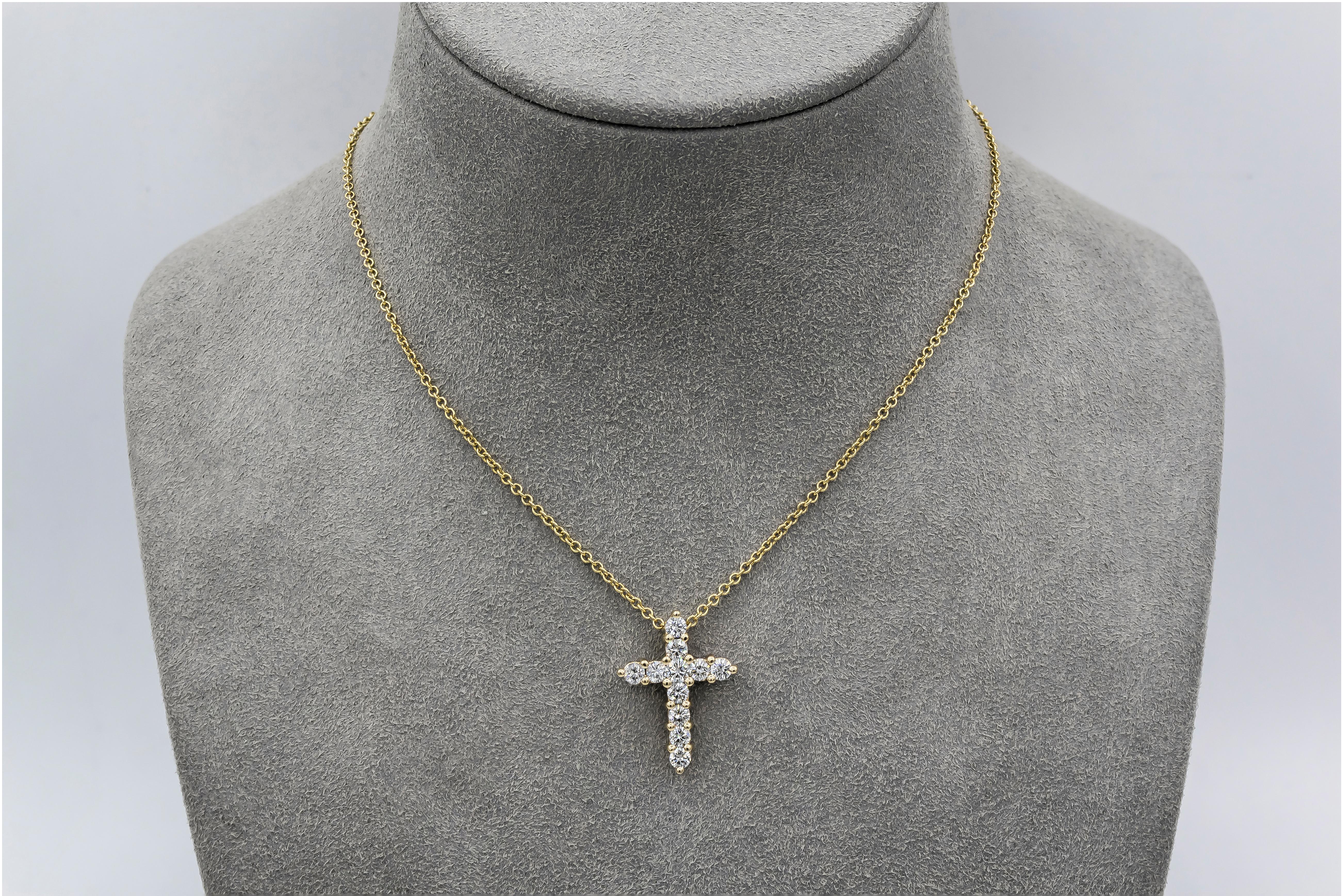 A classic cross pendant necklace showcasing round brilliant diamonds set in shared prongs made in 14 karat yellow gold. Suspended on an 18 inch yellow gold chain. 

Style available in different price ranges. Prices are based on your selection of the