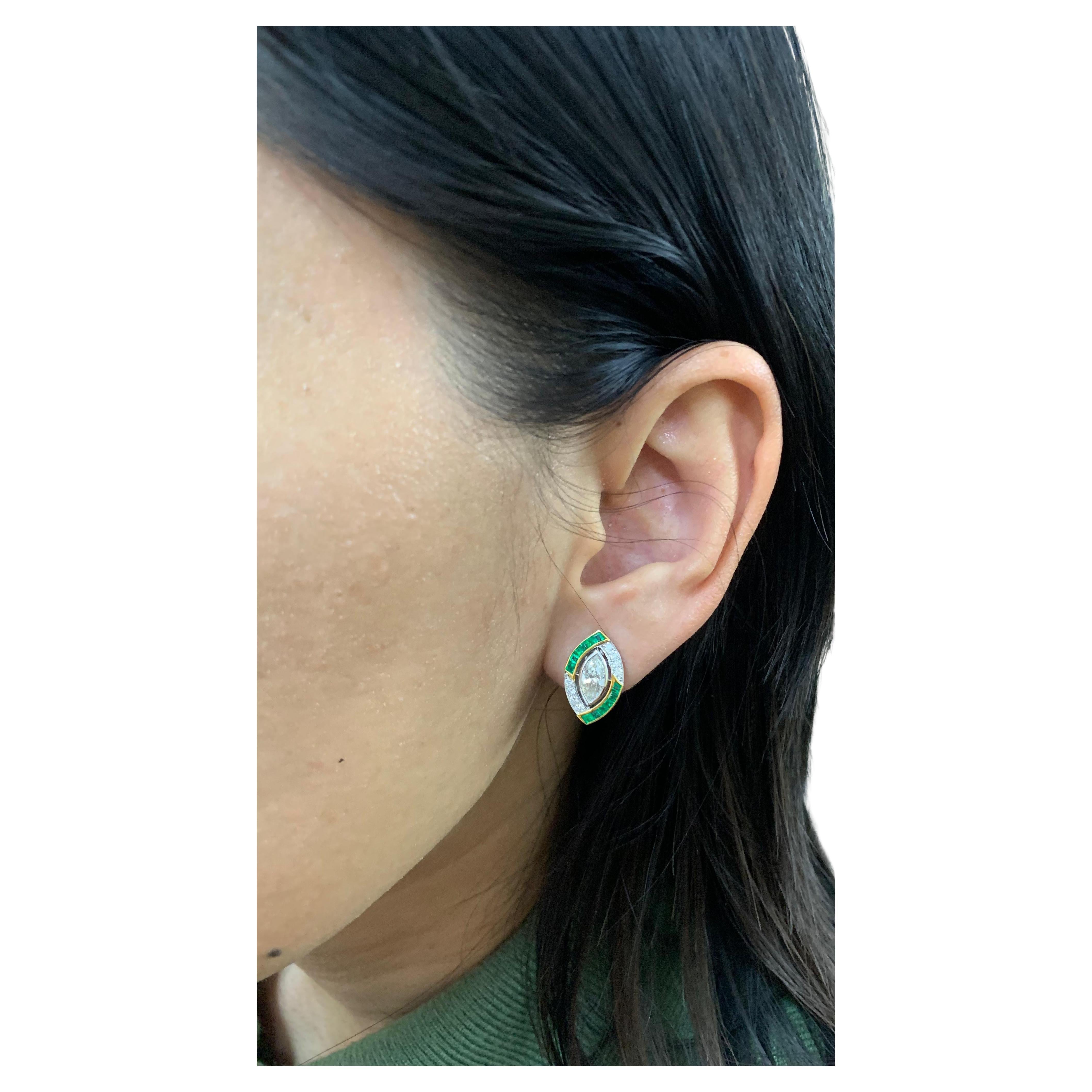 A pair of modern vintage diamond and emerald stud earrings from Rewa Jewels, inspired art deco themes.
- Two centre marquise weigh 1.04 carats
- Sixteen supporting round diamonds. The total weight is 0.20 carats
- Twenty four square shaped emeralds.