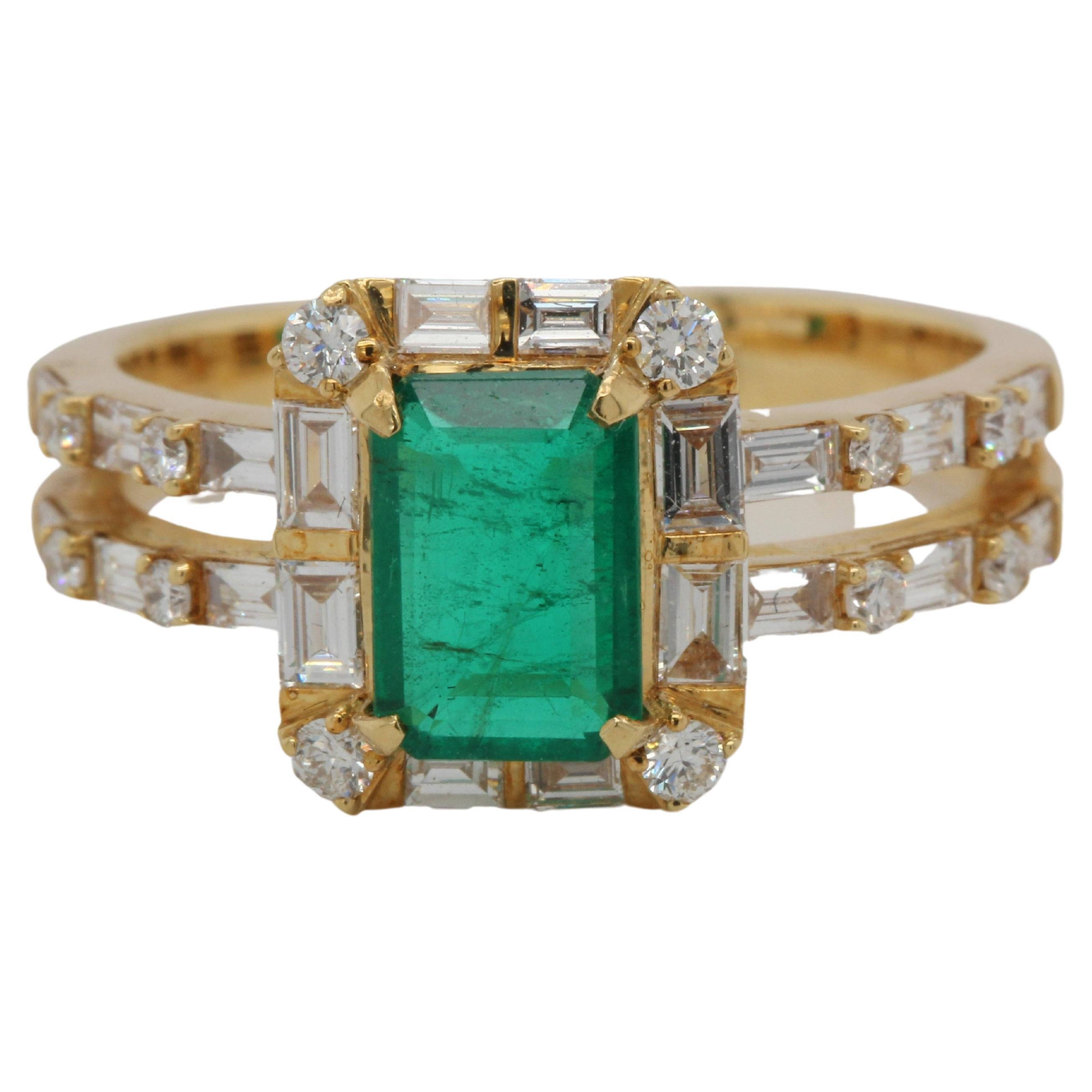 Our impeccable craftsmanship and attention to detail are evident in our refined emerald and diamond ring - a perfect example of our signature style. The 1.04 carat emerald emerald cut center stone is surrounded by 0.56 carat diamonds tapper down