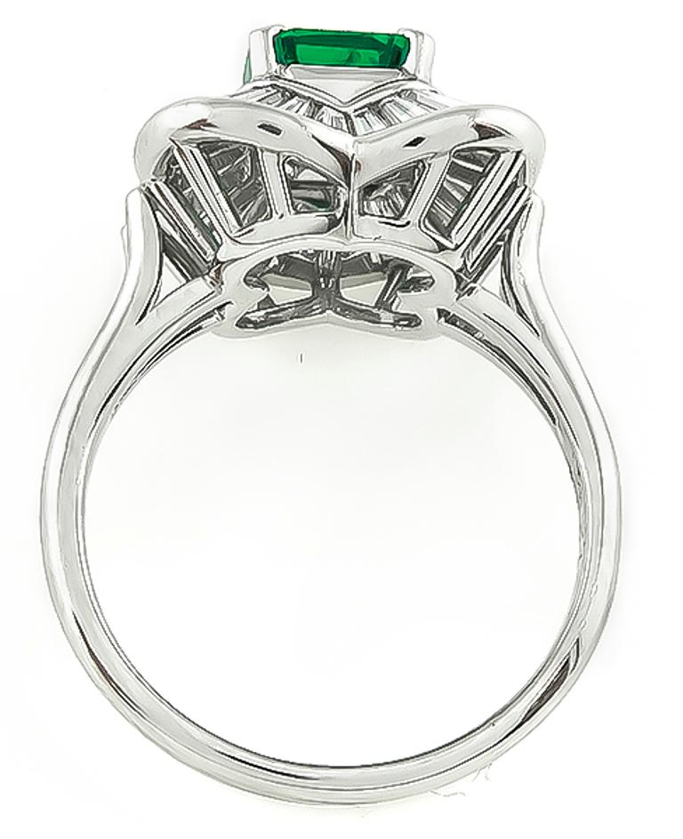 This amazing platinum cocktail ring is centered with a lovely emerald cut emerald that weighs 1.04ct. The emerald is accentuated by sparkling baguette cut diamonds that weigh 1.25ct. graded G color with VS clarity.  The ring is stamped Pt900 E 1.04