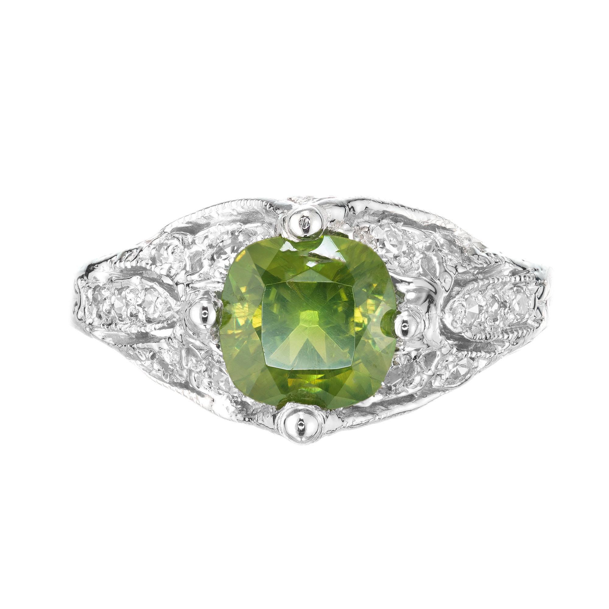 1920-1930 Art Deco demantoid garnet engagment ring. Antique cushion cut GIA center stone set in platinum with 16 round accent diamonds. Russian origin with a horse tail inclusion.

1 antique cushion green demantoid Garnet, approx. total weight