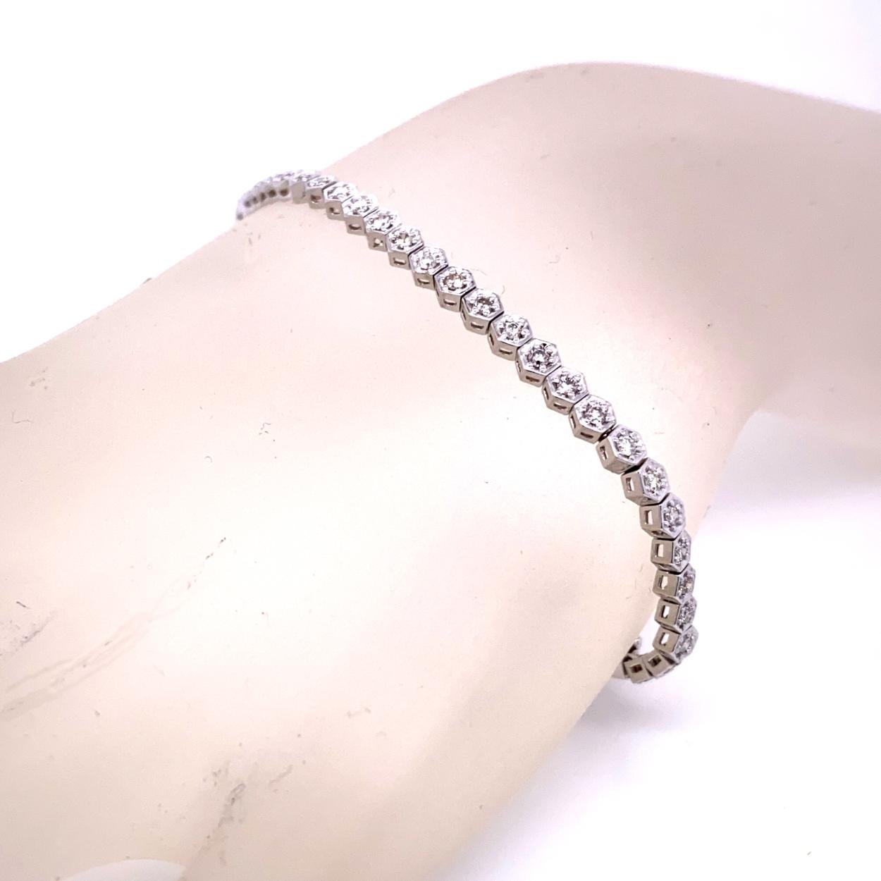 This Diamond Tennis Bracelet consists of 56 Links of Honeycomb Illusion Set 1.6mm Round Brilliant diamonds set in 14K White Gold.   The bracelet comes with a Safety Lock to protect it from loss. 
Total Weight of diamonds: 1.04 Ct 
Total Weight of