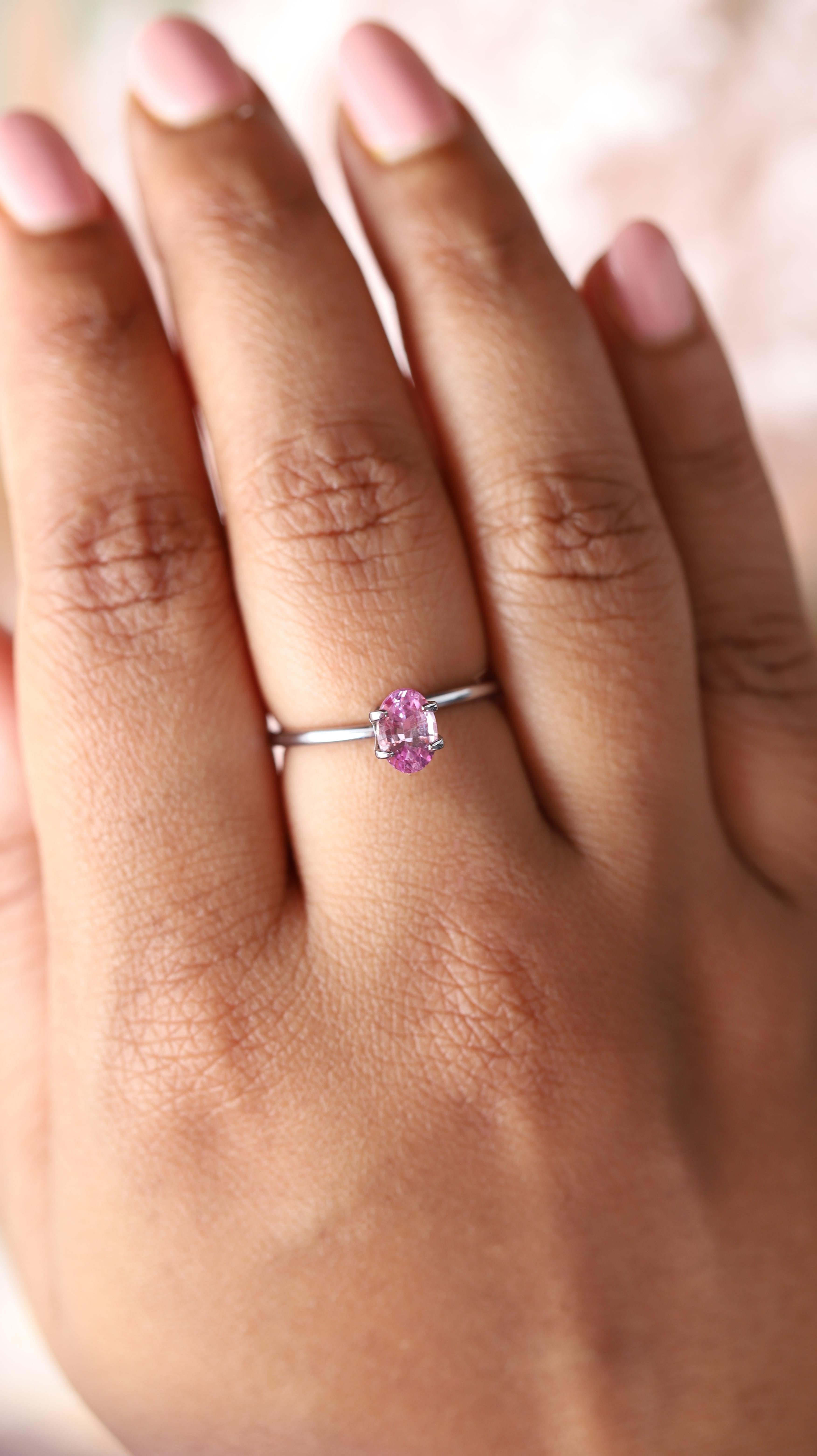 The magnificence of this rosy sapphire conjures images of the loveliest pink roses in full bloom. Its pristine facets shimmer brilliantly, showcasing the gem’s clean interior and radiating a soft pink glow from its elegantly shaped oval form.  