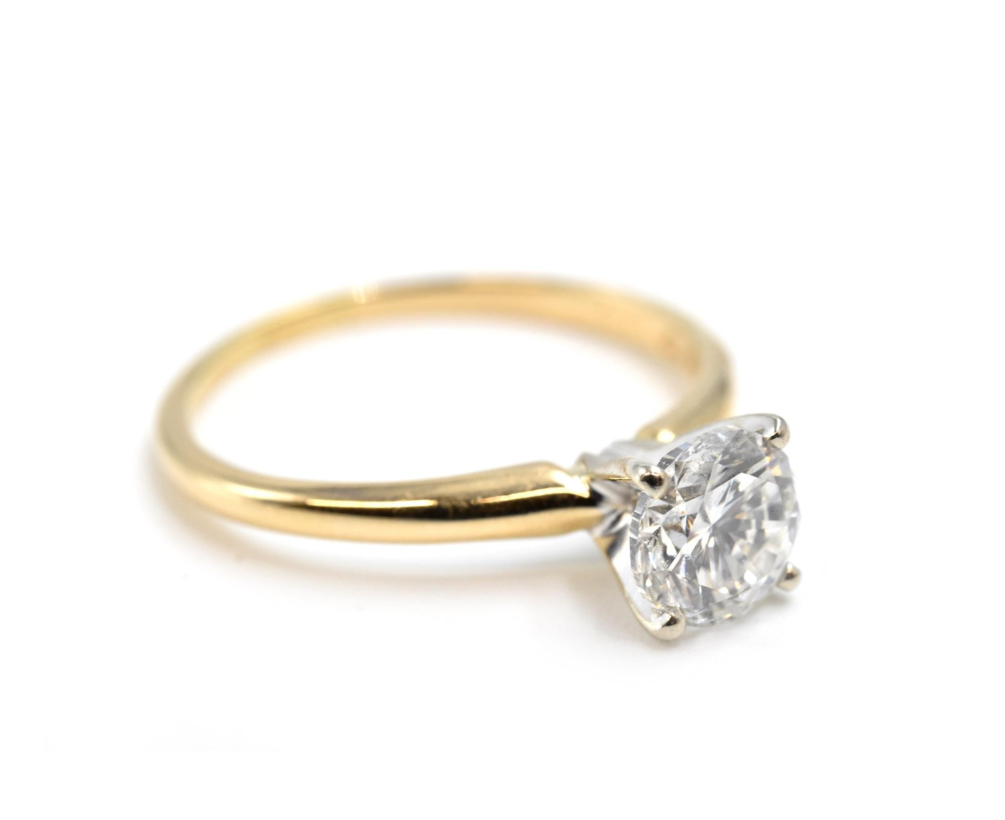 Designer: custom design
Material: 14k yellow gold
Center Stone: 1.04 carat round brilliant cut diamond
Color: H
Clarity: SI2
Ring Size: 7 1/2 (please allow two additional shipping days for ring to be sized)  
Weight: 2.22 grams

