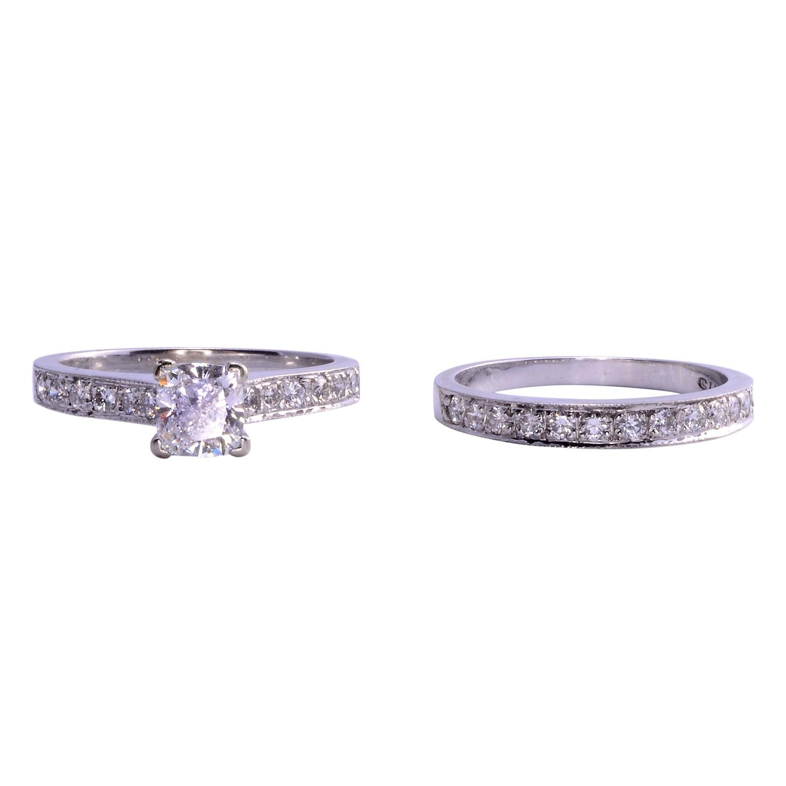 Estate 1.04 carat VS1 E center diamond wedding set. The 14 karat white gold engagement ring features a 1.04 carat center diamond having VS1 clarity and E color. The center diamond is accented with 12 round brilliant diamonds on the band of the