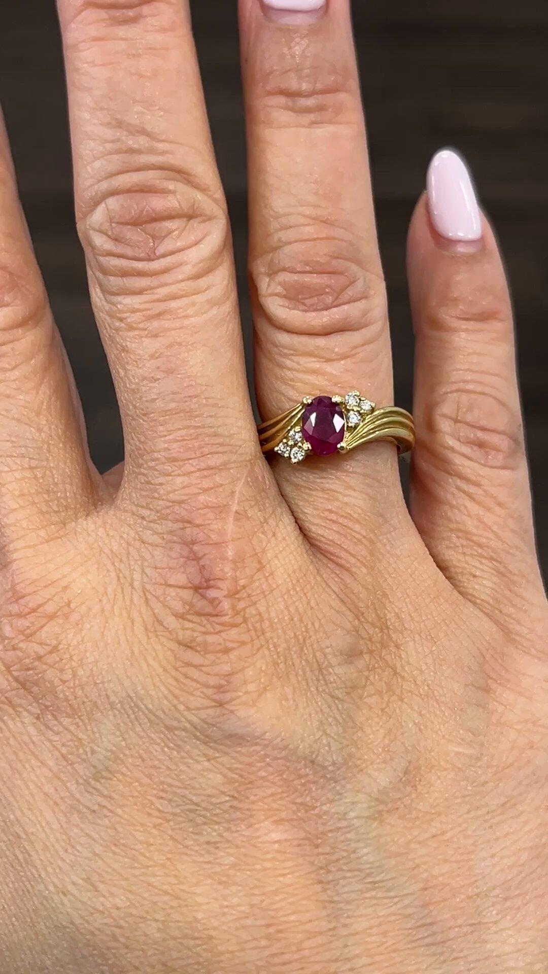 This stunning oval-shaped ring is crafted from 14k yellow gold and features a gorgeous 0.93 carat red ruby as its main stone. The ruby is accentuated by sparkling diamonds and set in an elegant design. The ring is size 5 3/4 and is made from