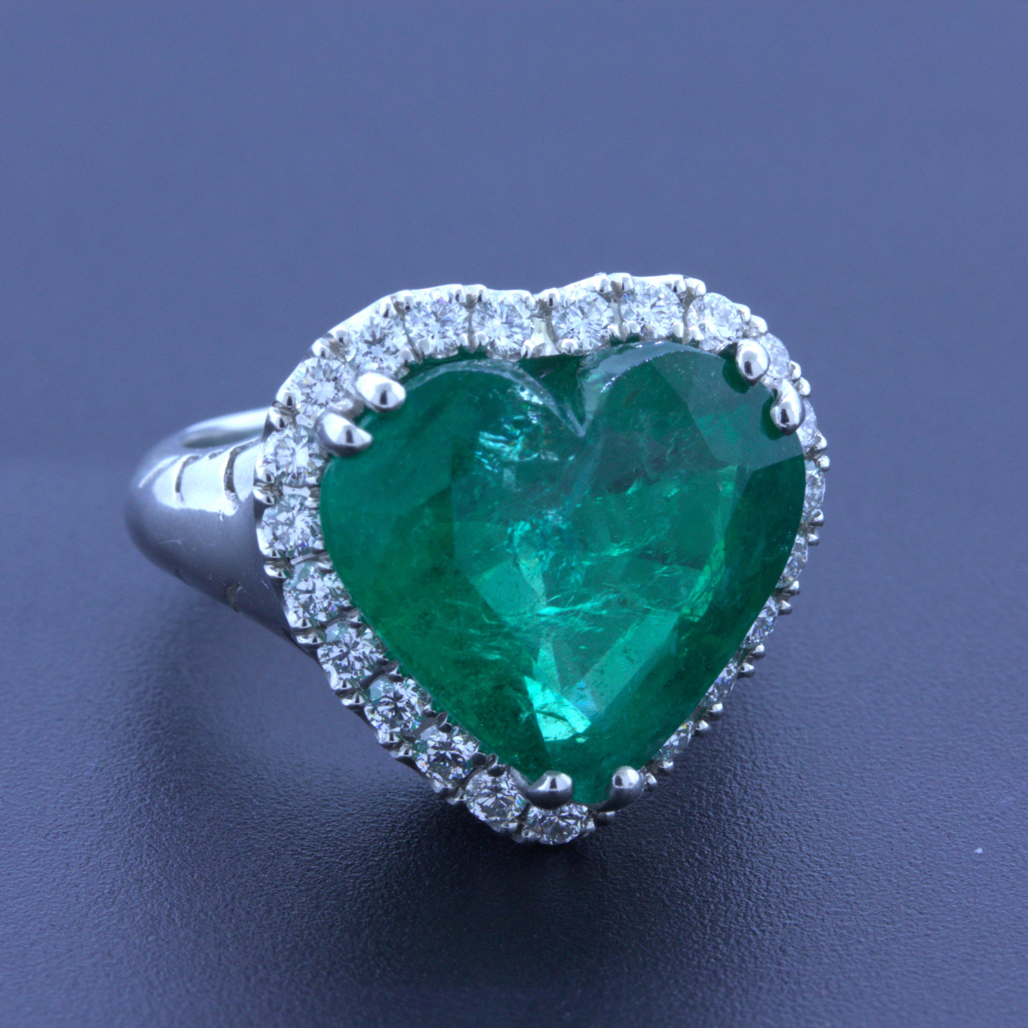 A large and impressive Colombian emerald takes center stage. It weighs 10.40 carats and has a unique heart-shape which is rarely seen in fine material like this. The emerald has a rich and bright grass green color that glows in the light. To find a
