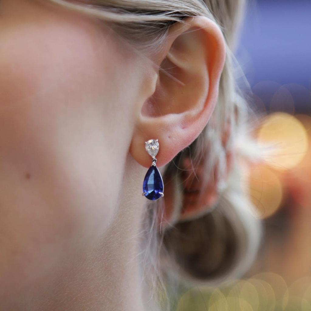 A pair of 10.40 carat sapphire and diamond pear on pear drop earrings in 18 Karat White Gold.

Each earring is set with a pear brilliant cut sapphire of 5.20 carats suspended from a matching pear brilliant cut diamond of 0.20 carats.

The sapphires