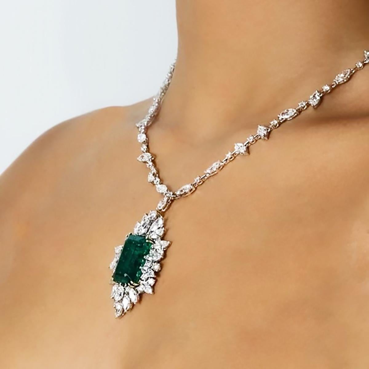 18k White gold necklace with one 19.42 carat very fine emerald and 54 Marquis cut and 55 round brilliant cut diamonds weighing approximately 25.00 carats. 