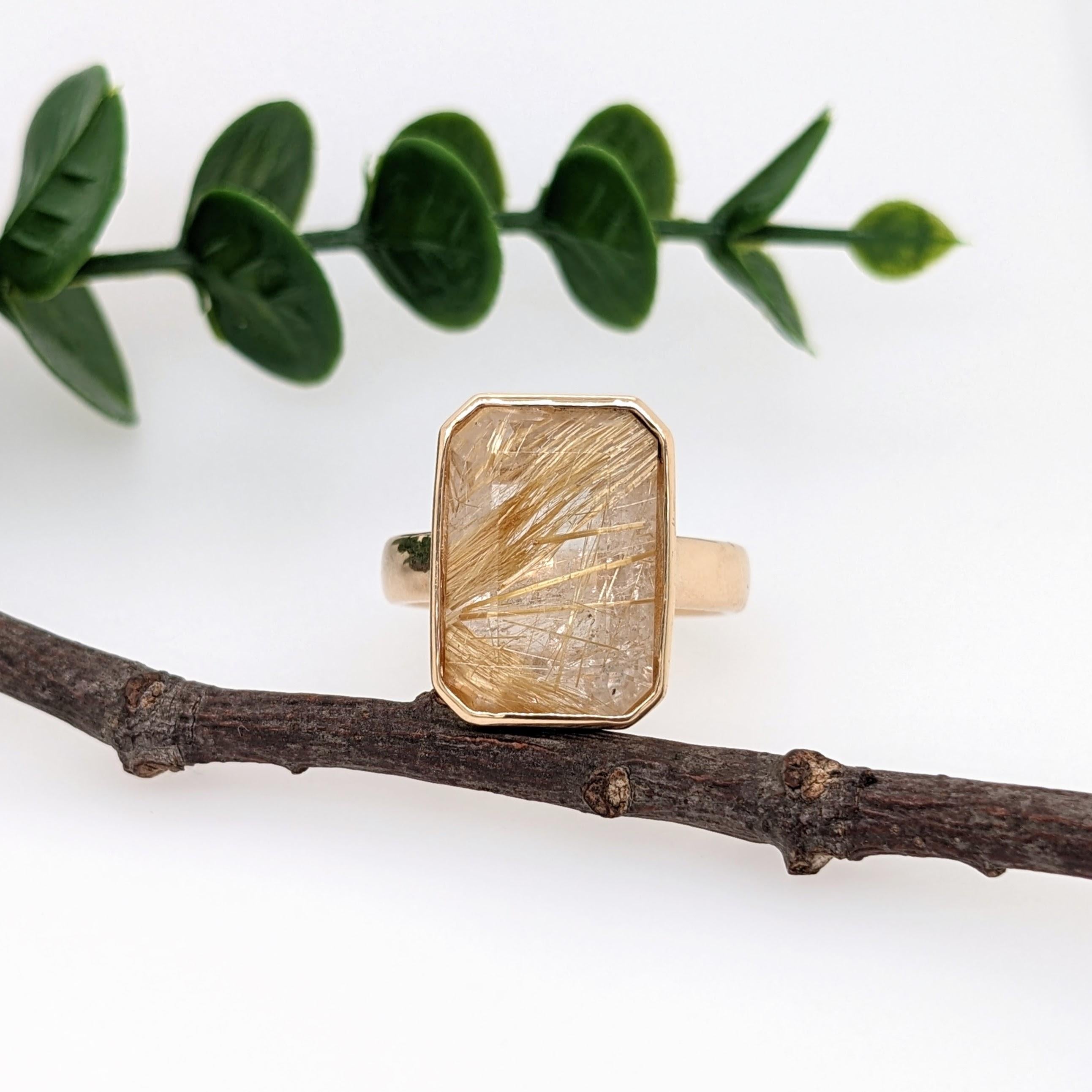 This elegant golden rutile quartz ring in 18K yellow gold is perfect to wear for any occasion. This solitaire ring features a emerald cut rutilated quartz set in a classic 18k gold mount with a straight comfort band. Would make a beautiful Christmas