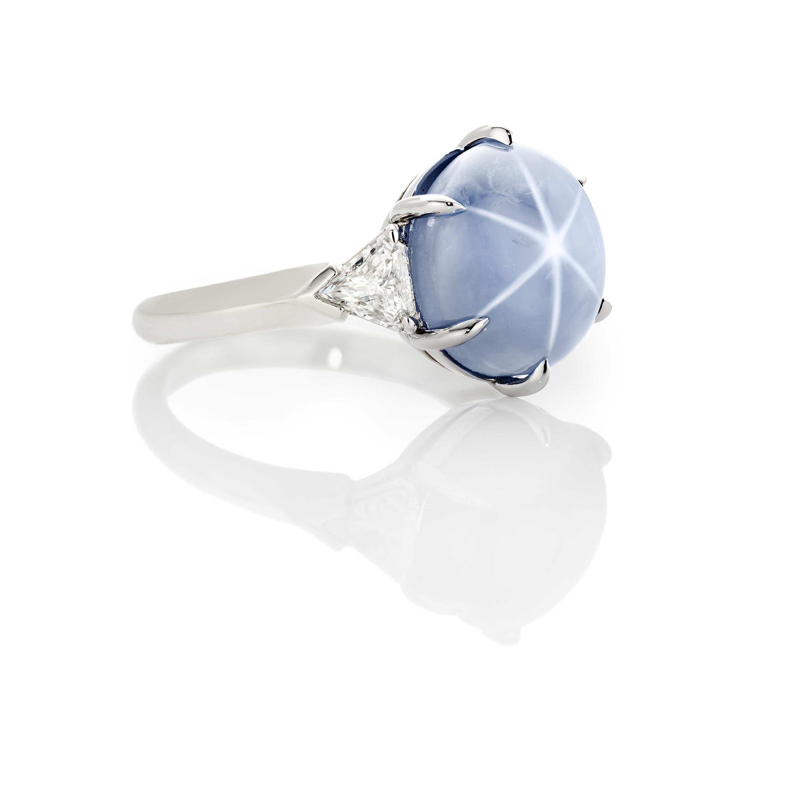 A classic ring is classic for a reason.  This ring is sophisticated and just lovely.  The Star Sapphire is Burmese, or some reference it as Magok, and untreated weighing 9.94 Carats.  There are two match Brilliant Cut Trillion Diamonds Weighing 0.52