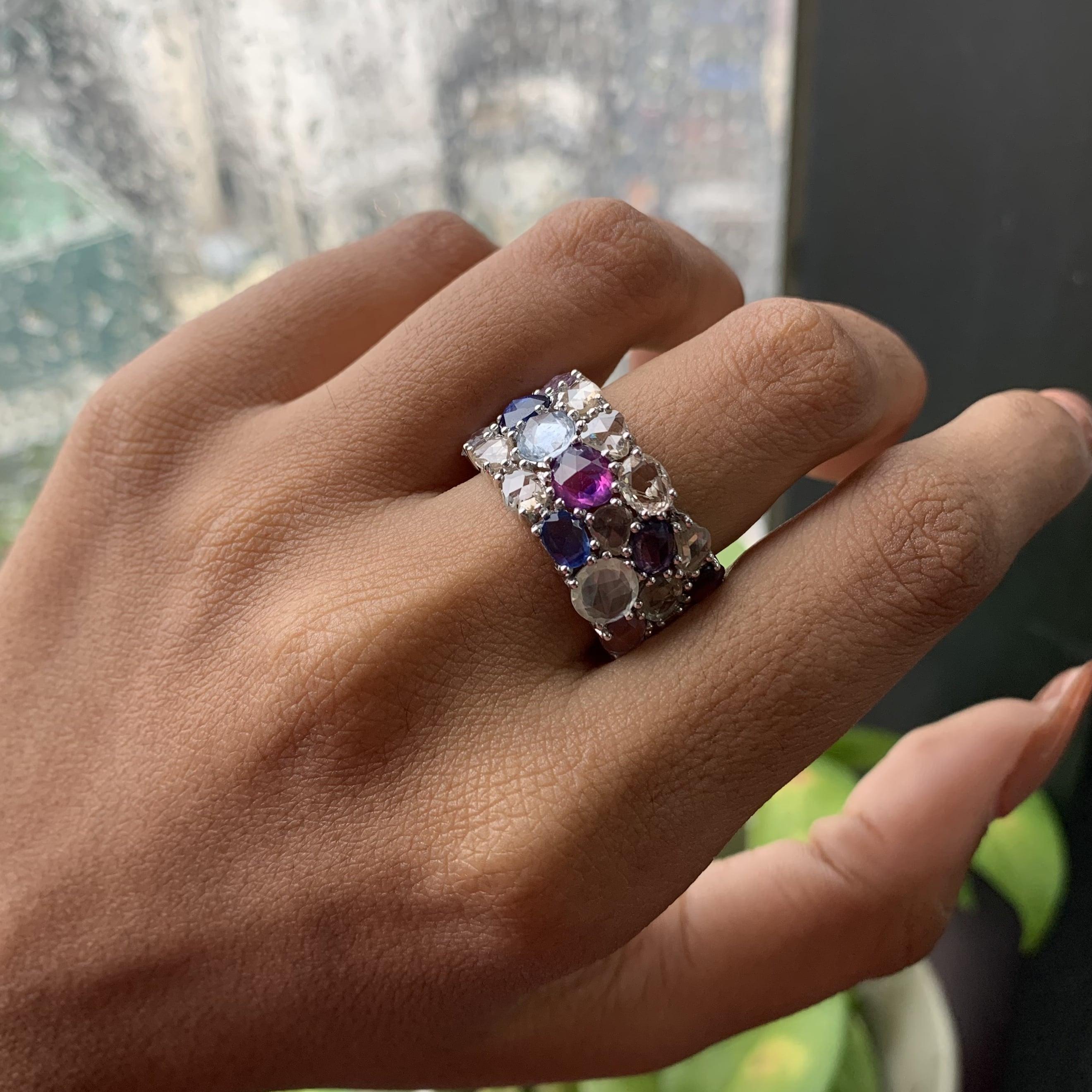 This ring is crafted from 14K White Gold and adorned with an impressive array of 10.48 Carat Multi Sapphires. These sapphires, in a rose cut style, capture just the right amount of light to showcase their vibrant colors beautifully. Additionally,