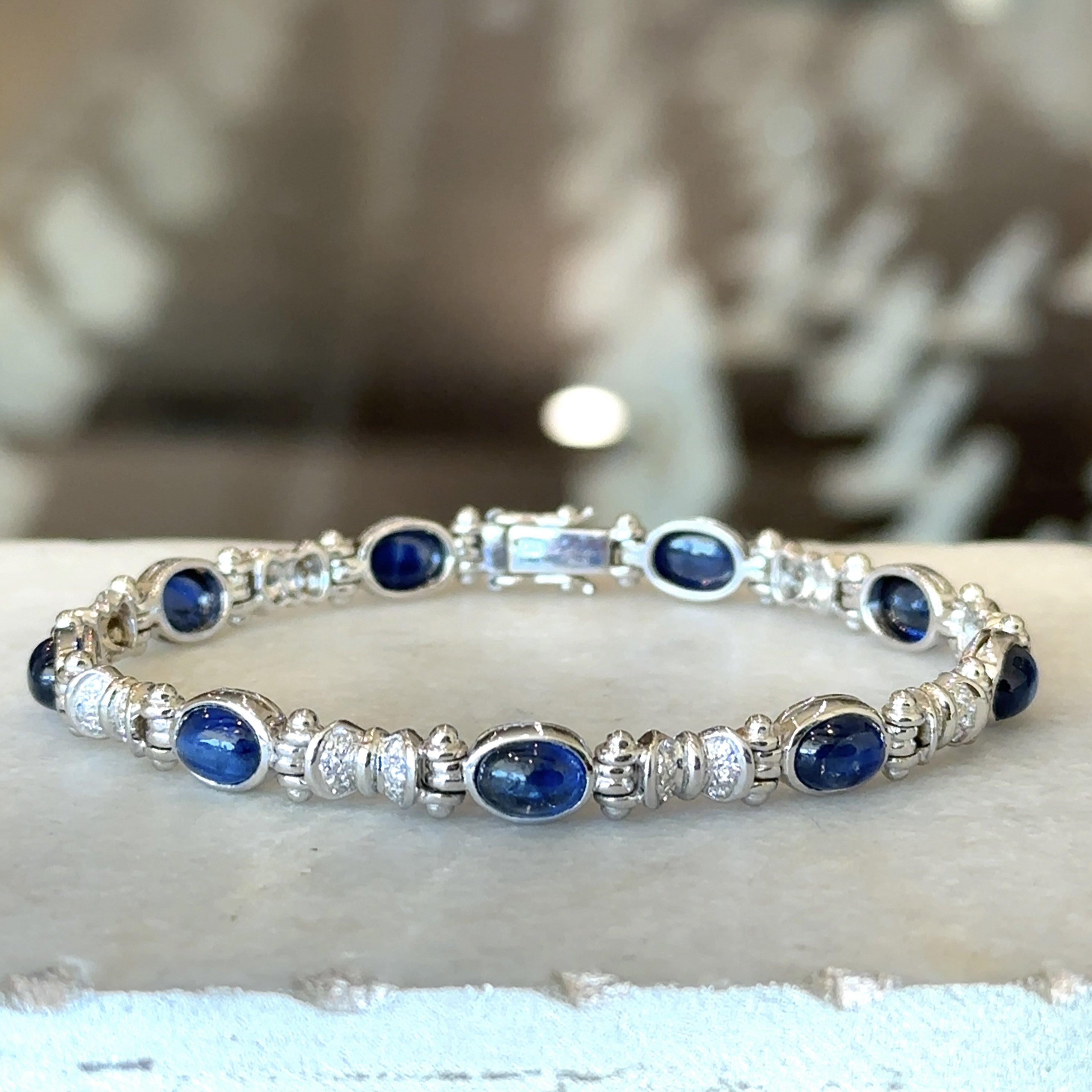 This Beautiful Bracelet is Crafted in 18KT White Gold
9.88cts of Stunning Blue Oval Cabochon Sapphires
.60cts of Brilliant Round Diamonds
The Blue Sapphires measure 9mm x 6mm and are Bezel Set
The Width of the Bracelet is .25